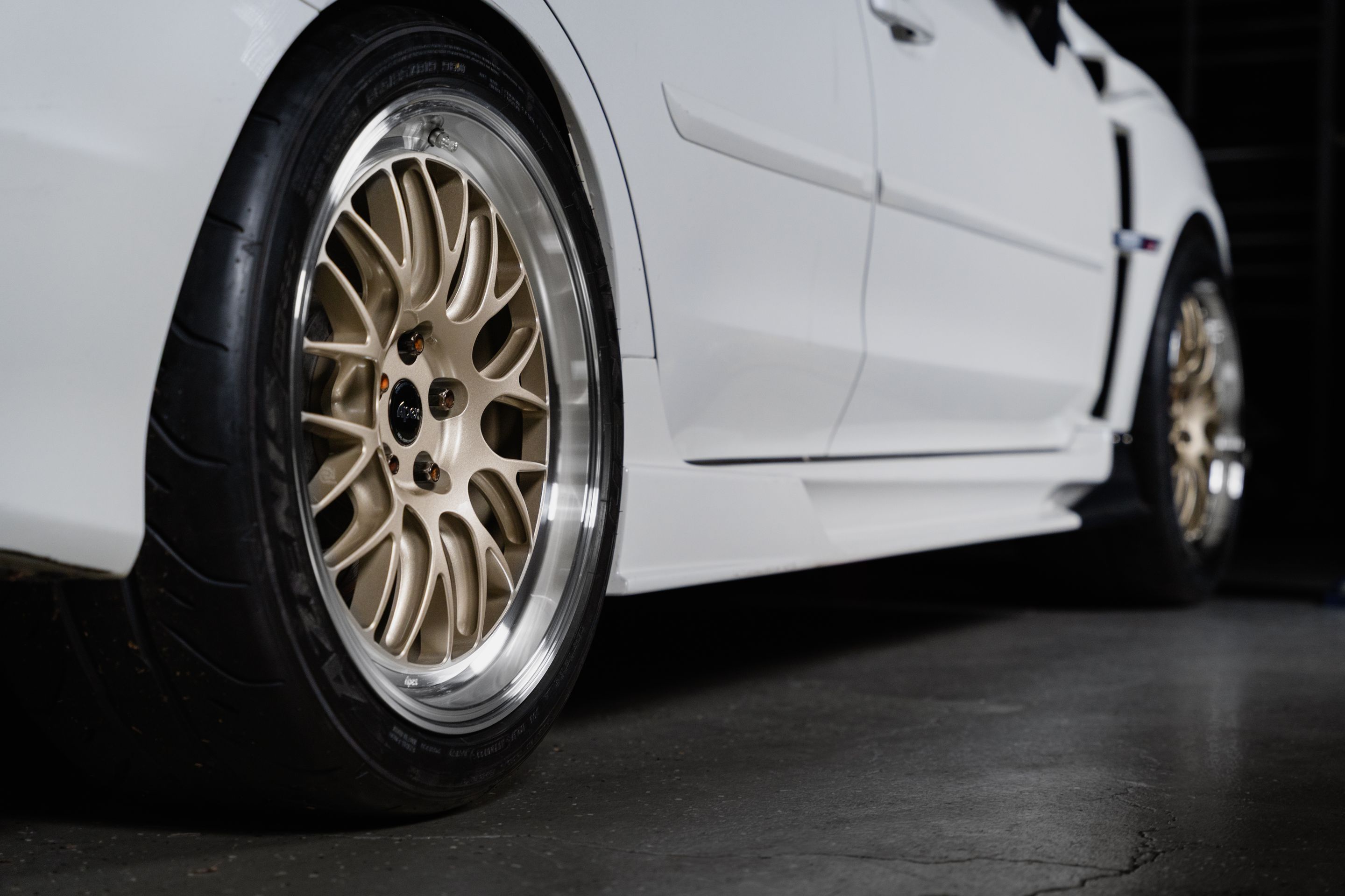 White Subaru VA WRX STI with 18" ML-10RT Apex wheels in Machined Lip Gloss Motorsport Gold