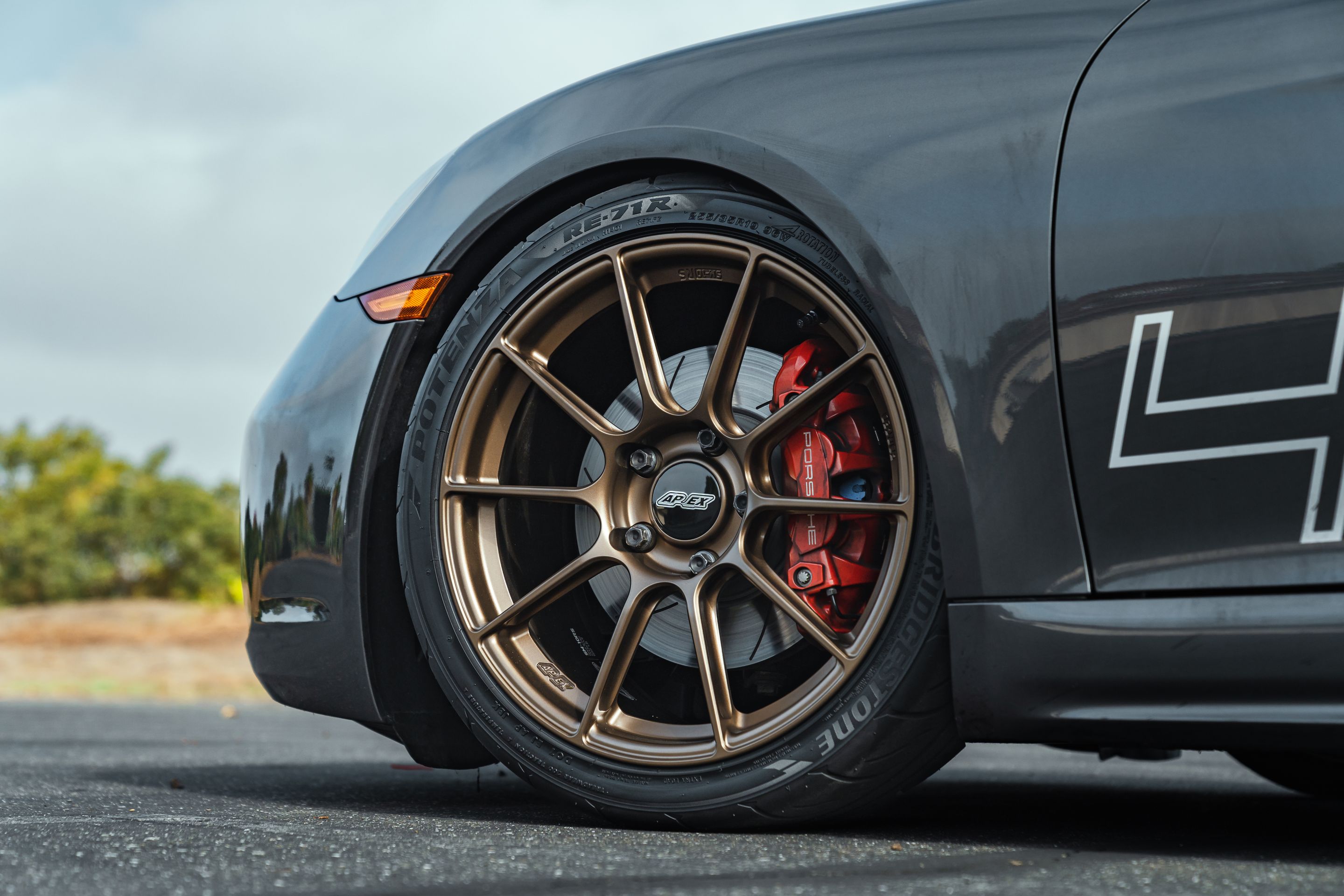 Grey Porsche 718 Cayman S with 19" SM-10RS Apex wheels in Satin Bronze