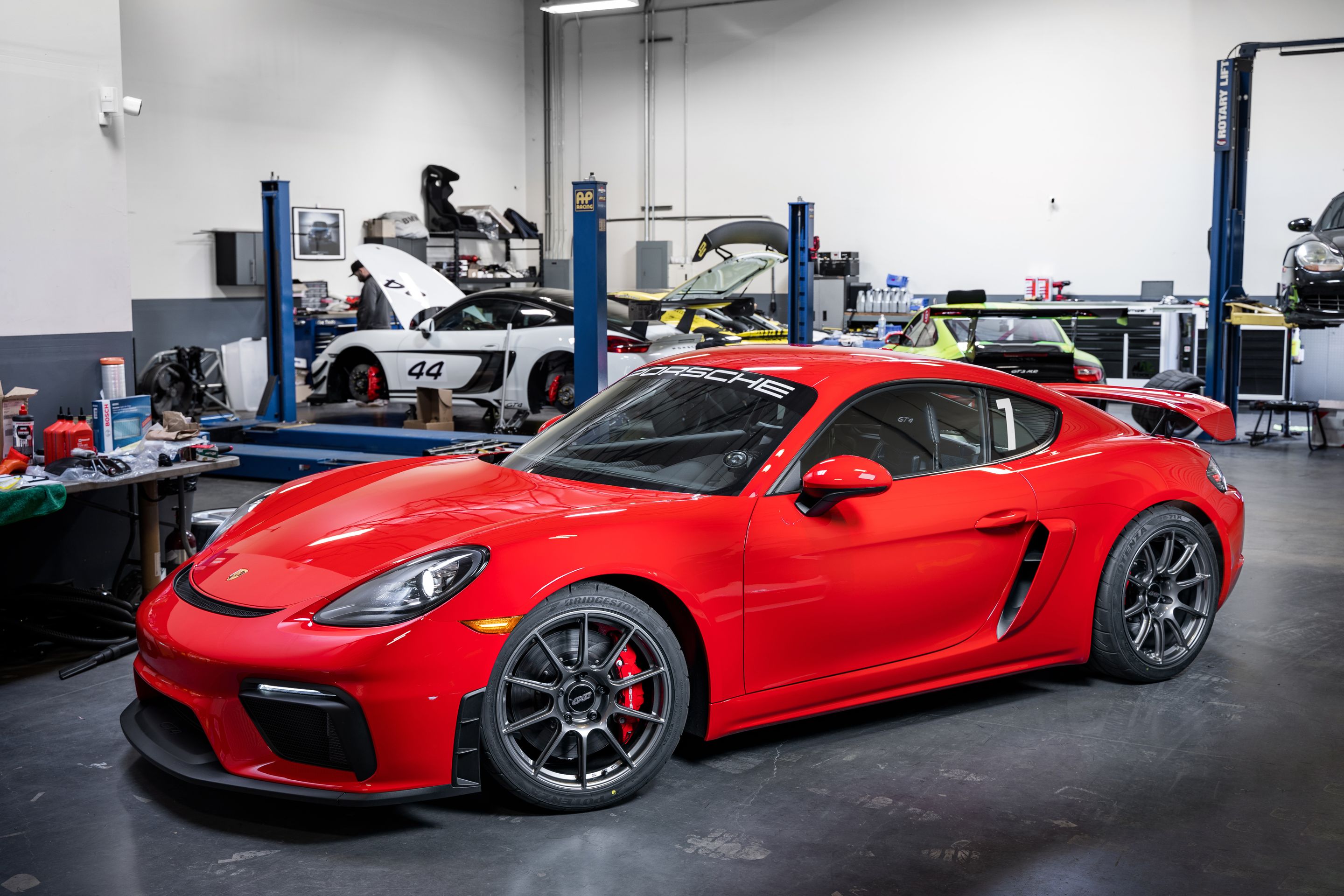 Red Porsche 718 Cayman GT4 with 19" SM-10 Apex wheels in Anthracite