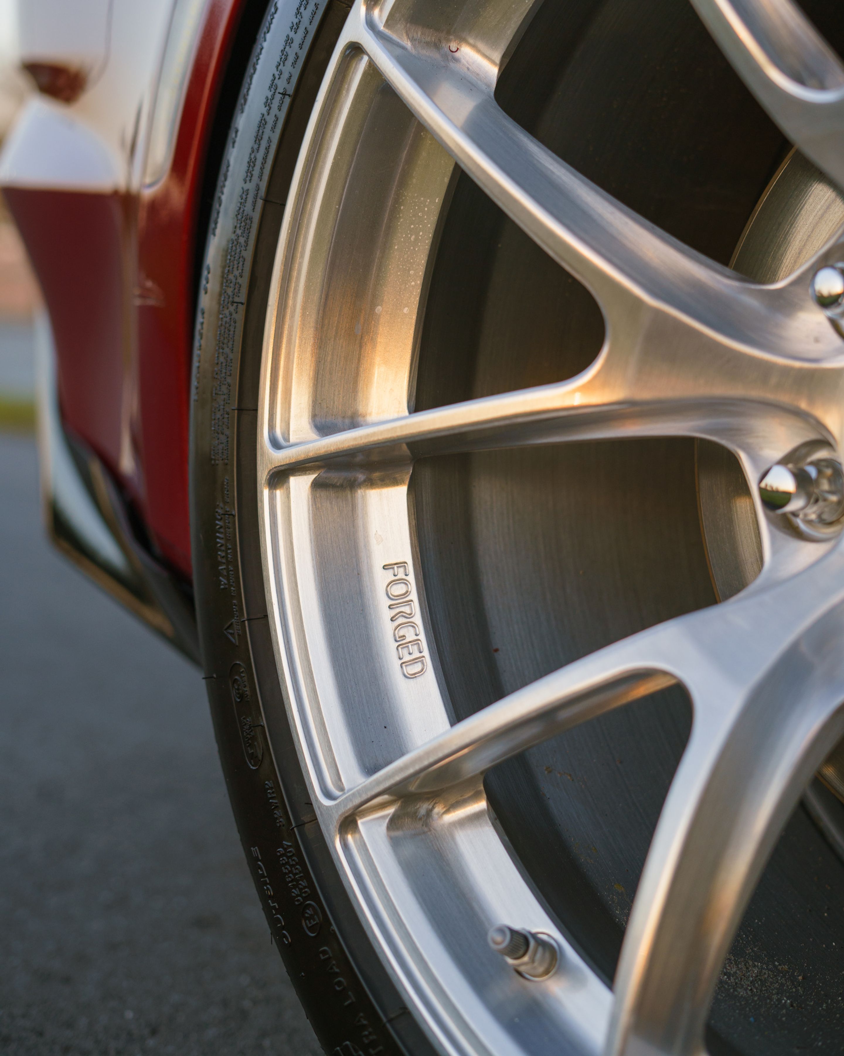 Red Chevrolet 6th Gen Camaro LT1 with 19" VS-5RS Apex wheels in Brushed Clear