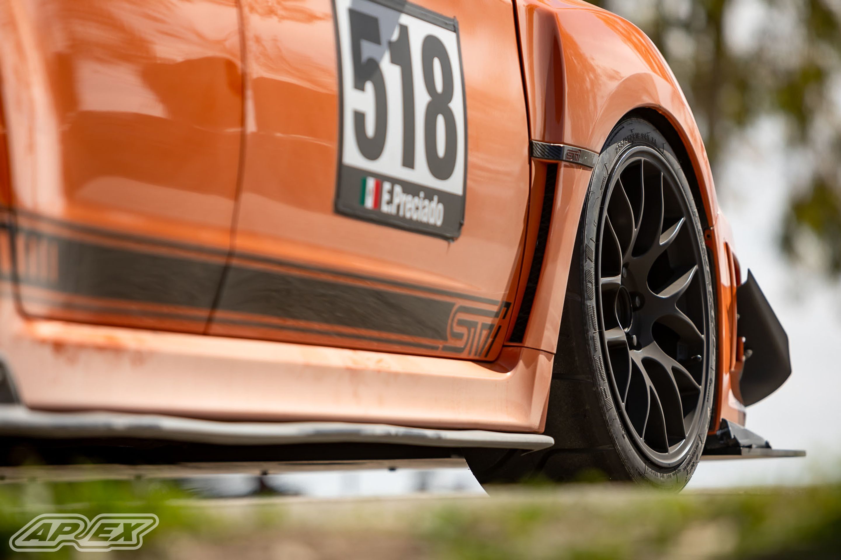 Orange Subaru GR WRX STI with 18" EC-7 Apex wheels in Satin Black