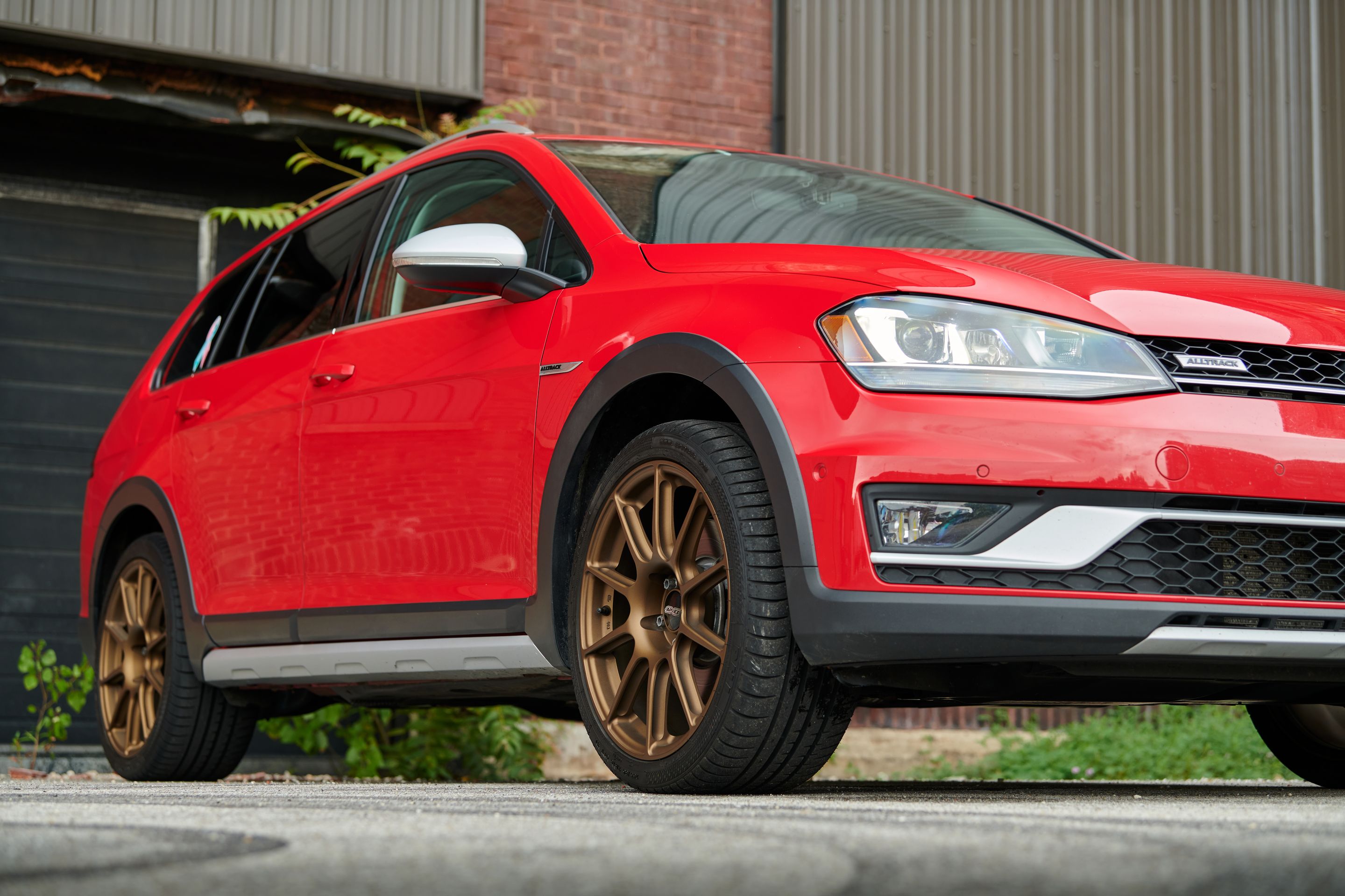 Red VW MK7 Alltrack/SportWagen Alltrack with 18" SM-10 Apex wheels in Satin Bronze