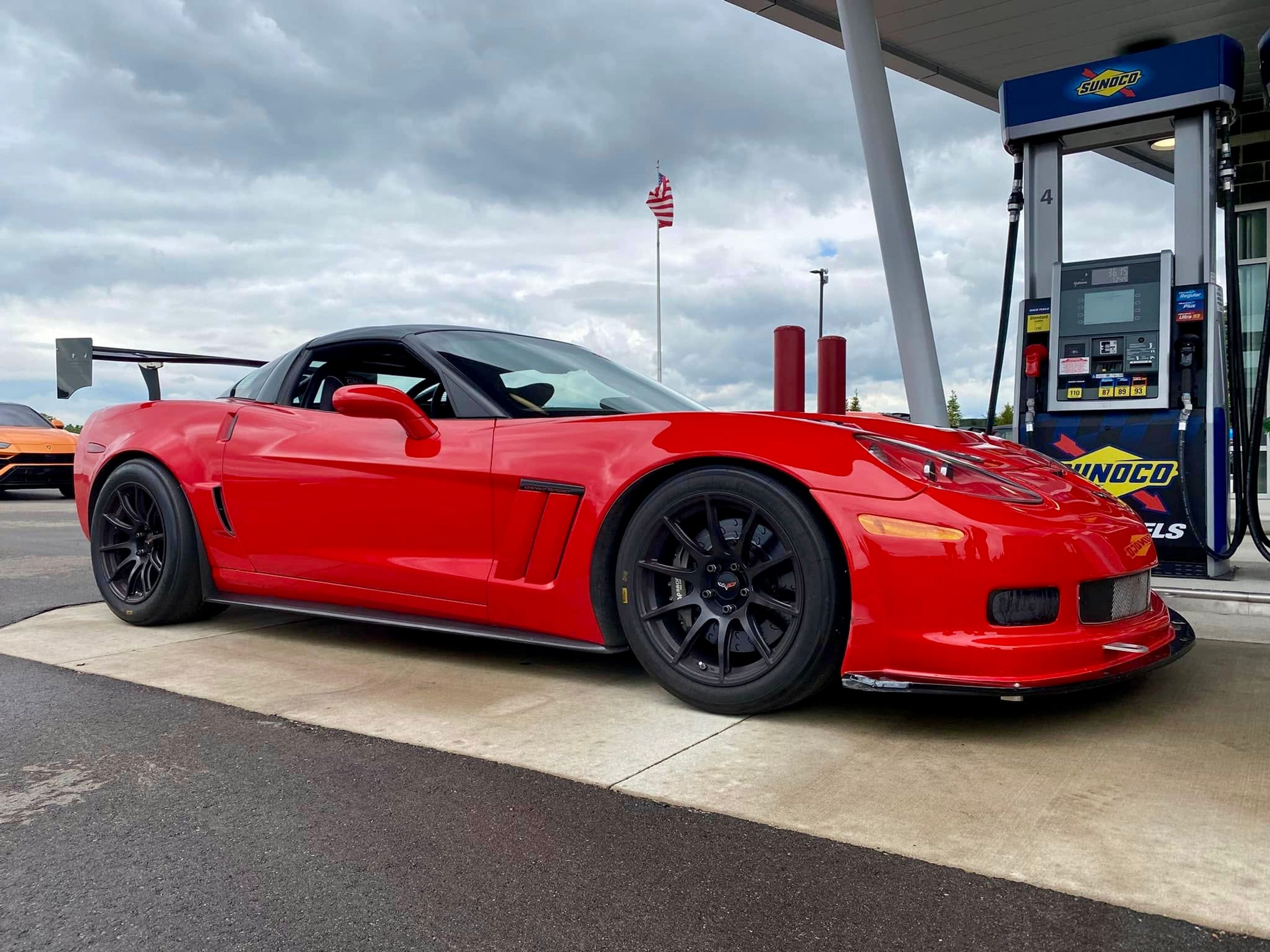 Red Chevrolet C6 Corvette Grand Sport with 18" SM-10 Apex wheels in Satin Black