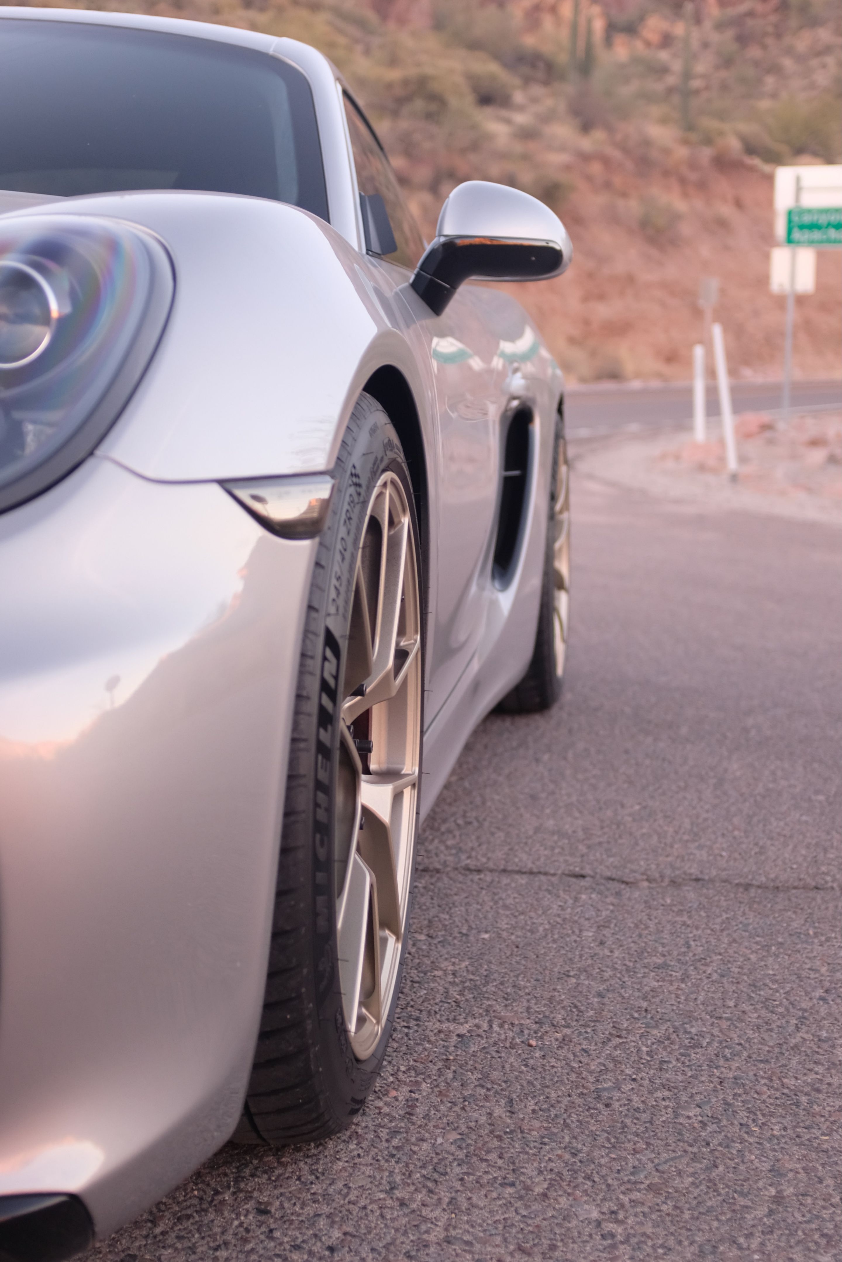 Silver Porsche 981 Cayman GTS with 19" VS-5RS Apex wheels in Motorsport Gold