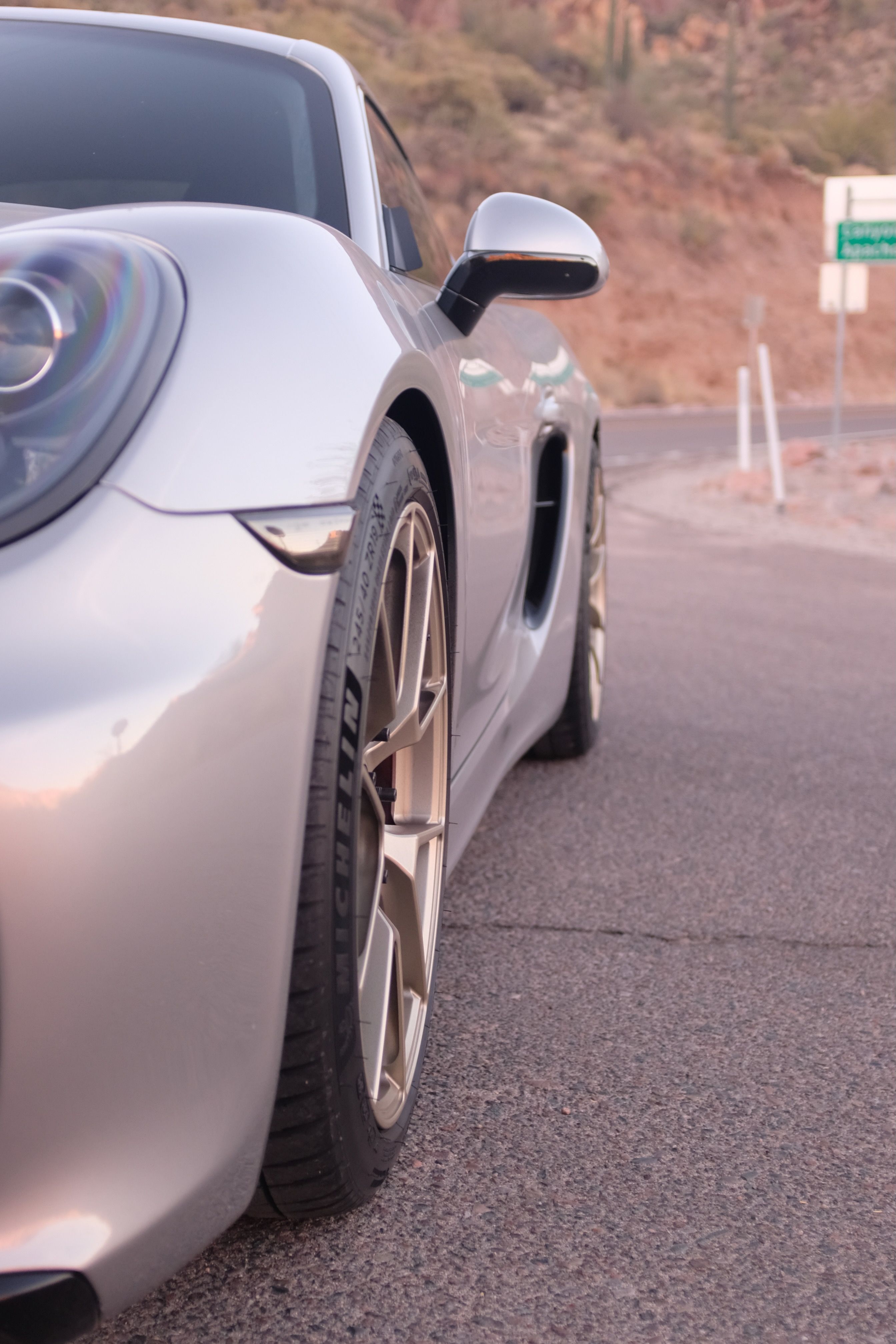 Silver Porsche 981 Cayman GTS with 19" VS-5RS Apex wheels in Motorsport Gold