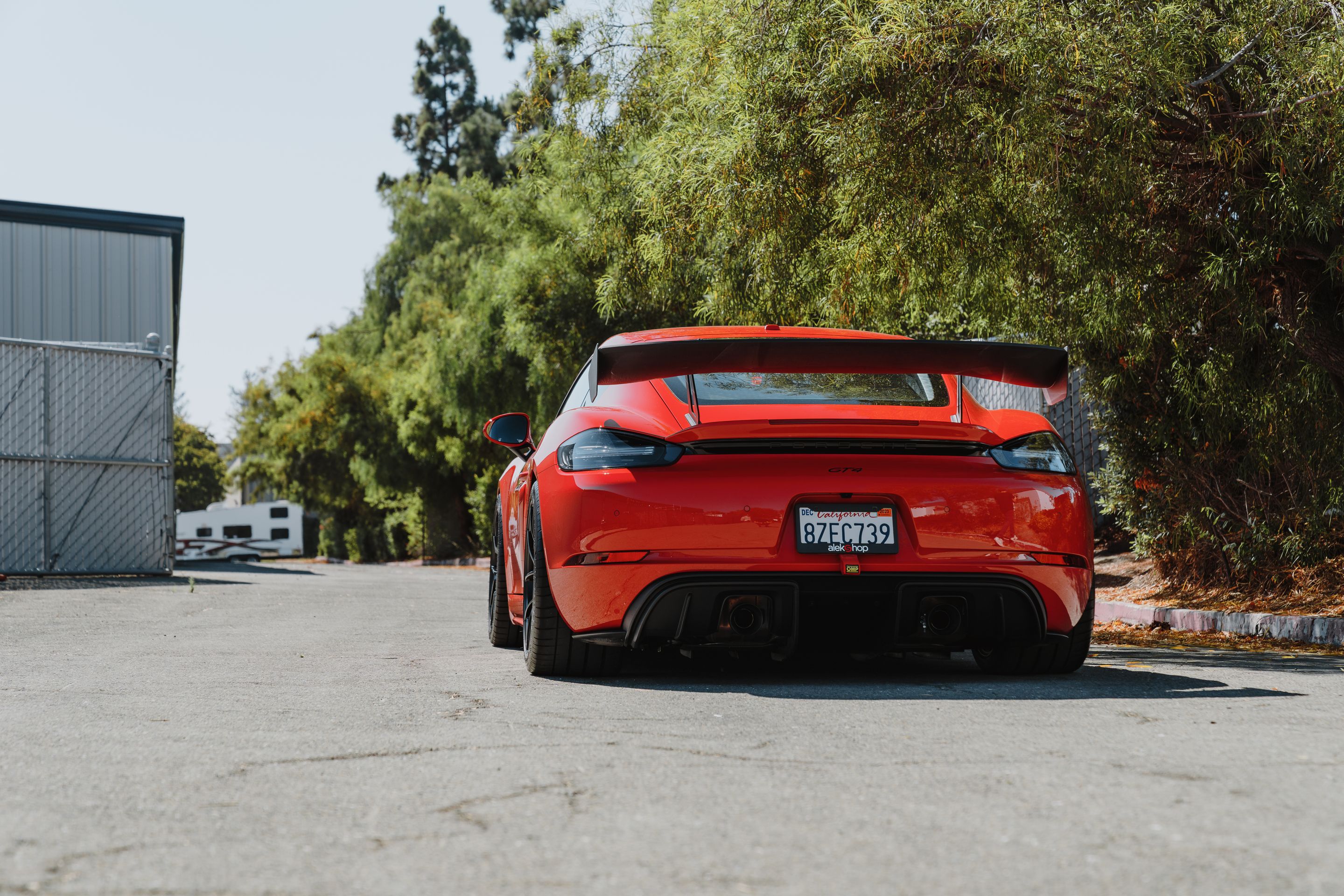 Red Porsche 718 Cayman GT4 with 19" VS-5RS Apex wheels in Satin Black