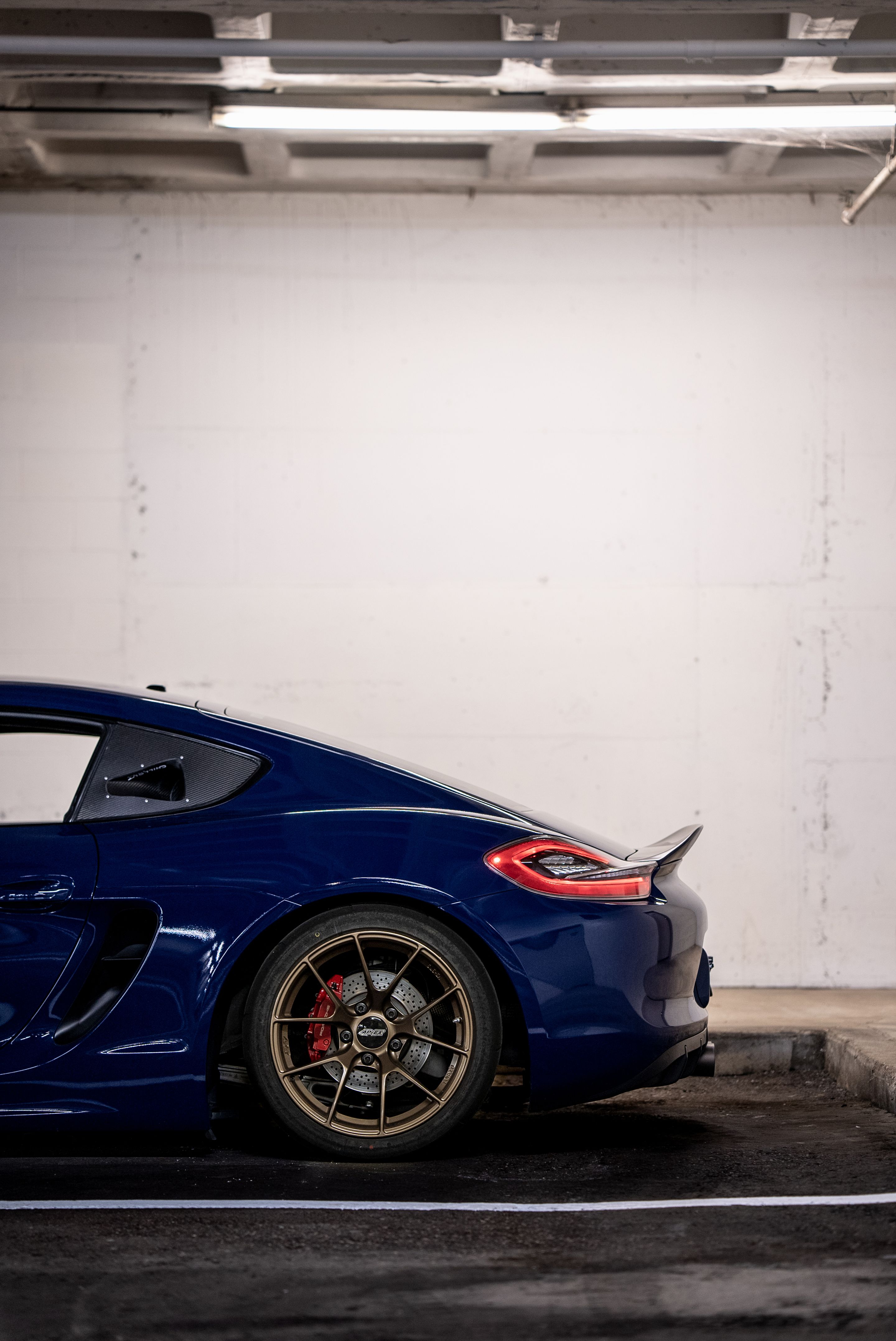 Blue Porsche 981 Cayman GTS with 18" VS-5RS Apex wheels in Satin Bronze