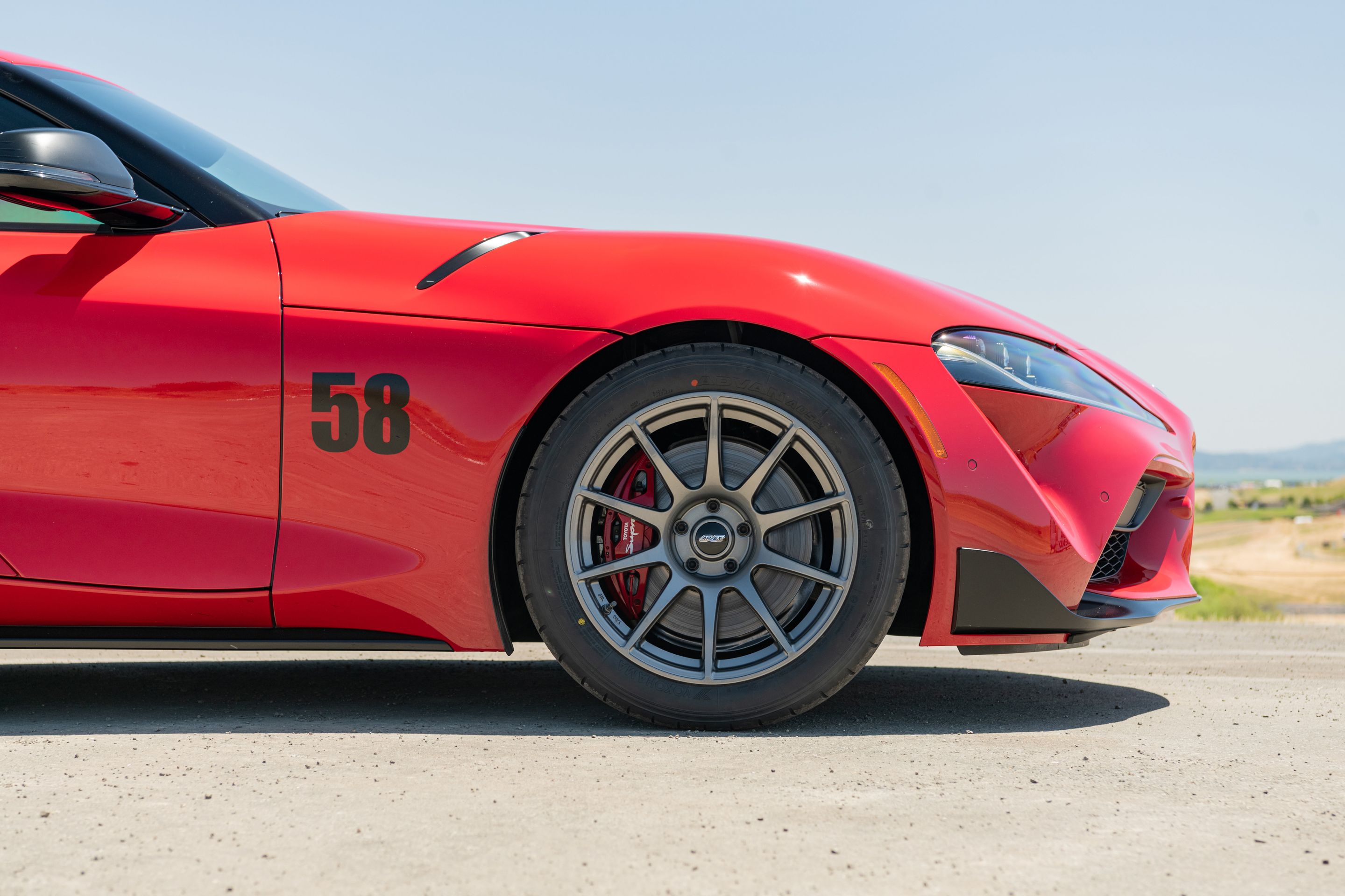 Red Toyota GR Supra with 18" SM-10 Apex wheels in Anthracite