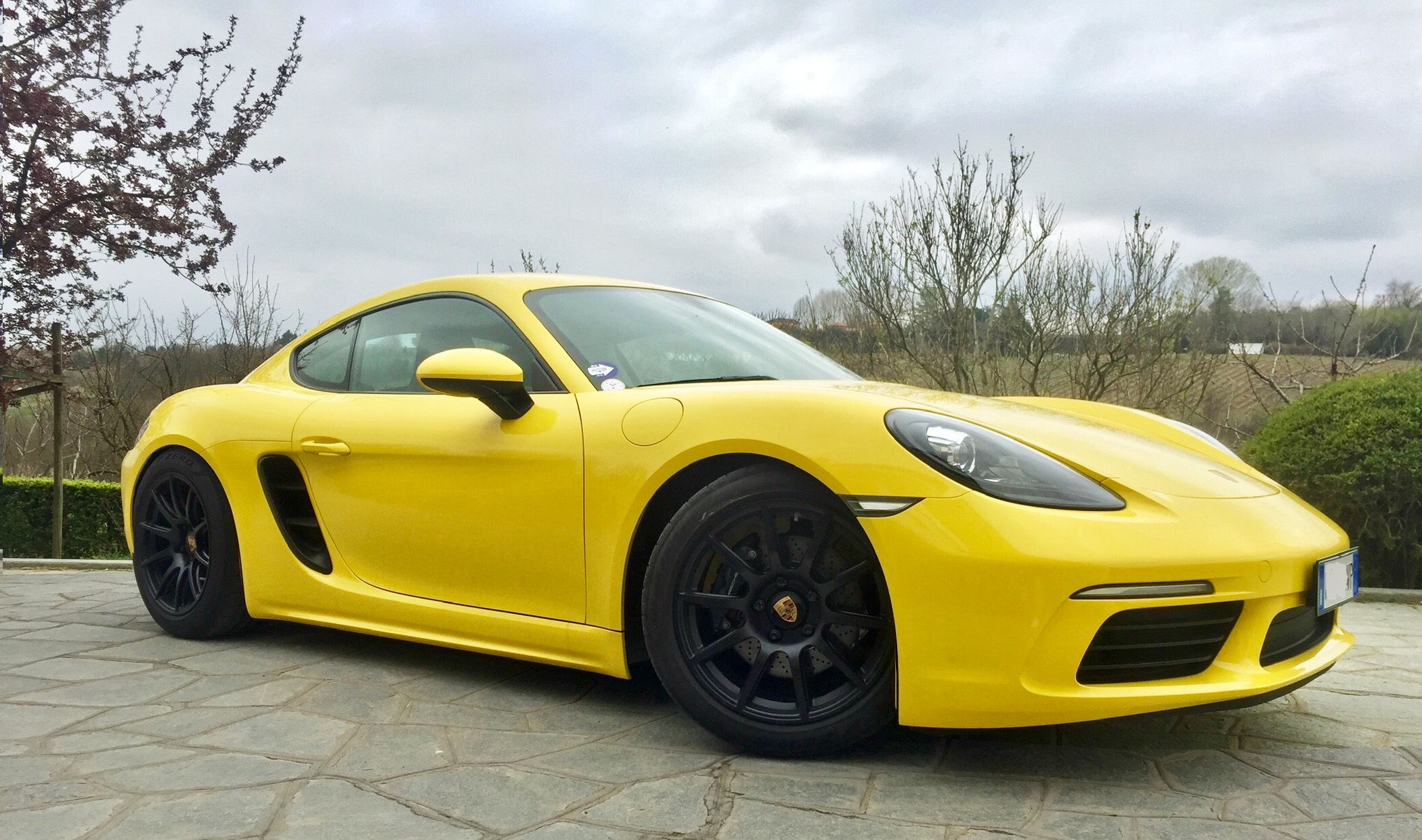 Yellow Porsche 718 Cayman Base with 18" SM-10 Apex wheels in Satin Black