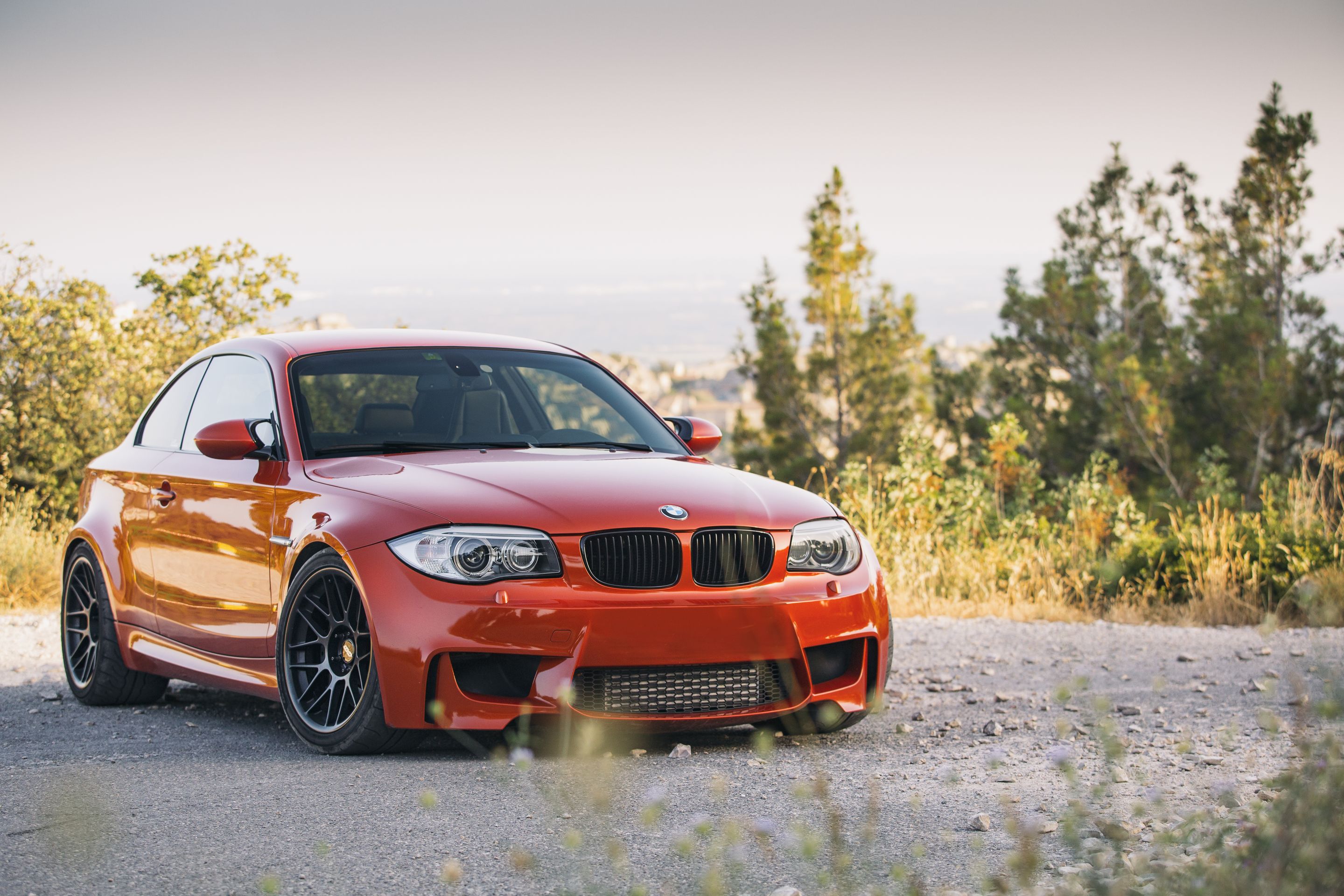 Orange BMW E82 1M with 18" ARC-8 Apex wheels in Satin Black