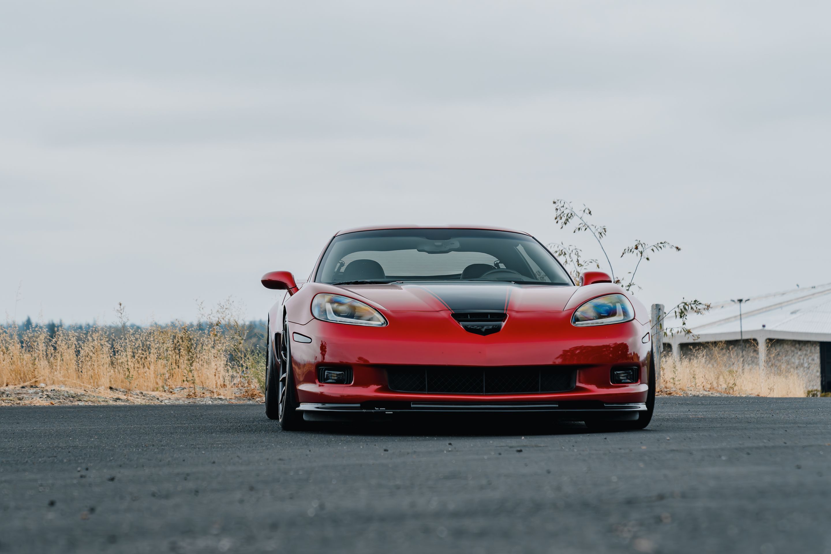 Red Chevrolet C6 Corvette Z06 with 18"/19" SM-10 Apex wheels in Satin Black