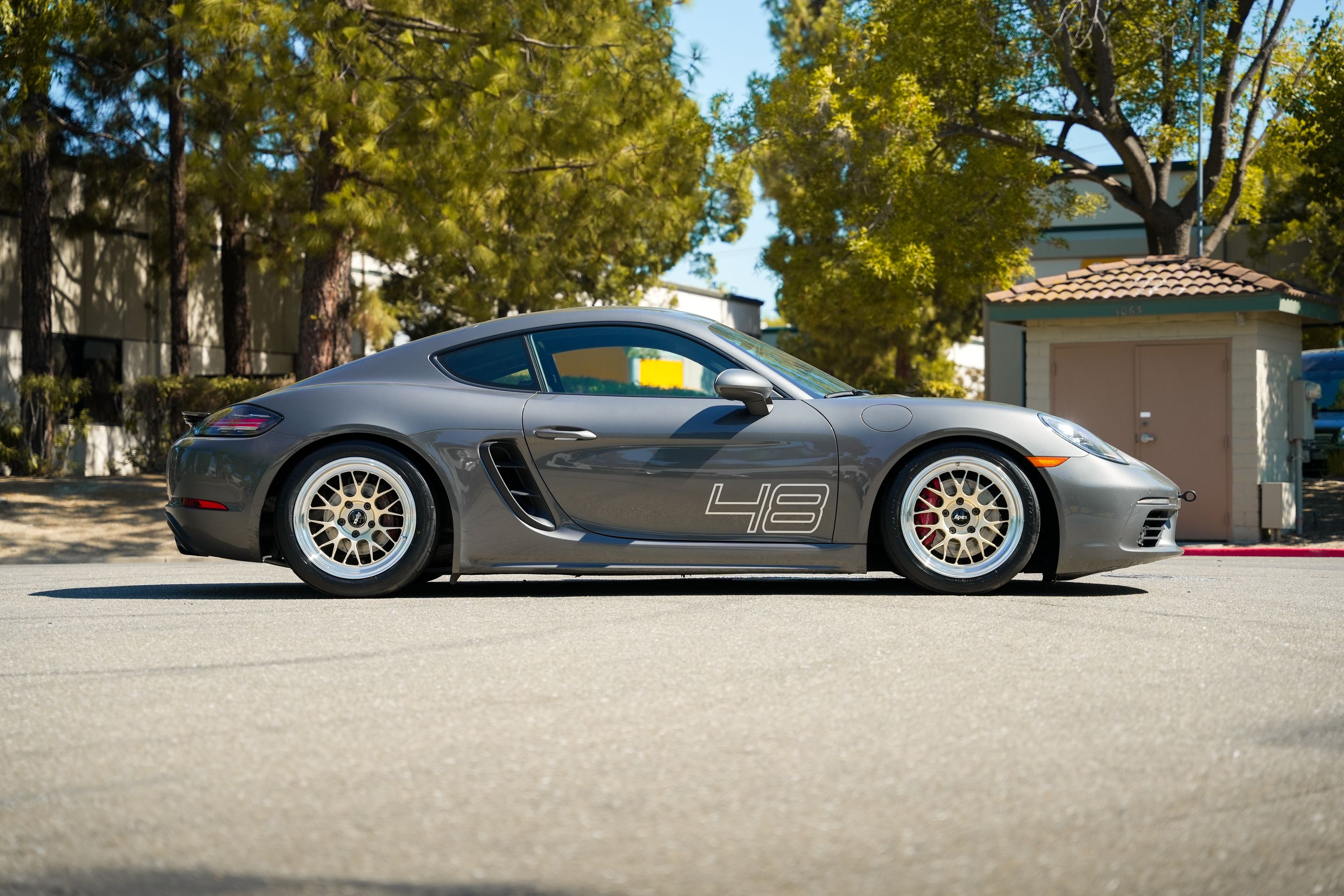 Grey Porsche 718 Cayman S with 18" ML-10RT Apex wheels in Machined Lip Gloss Motorsport Gold