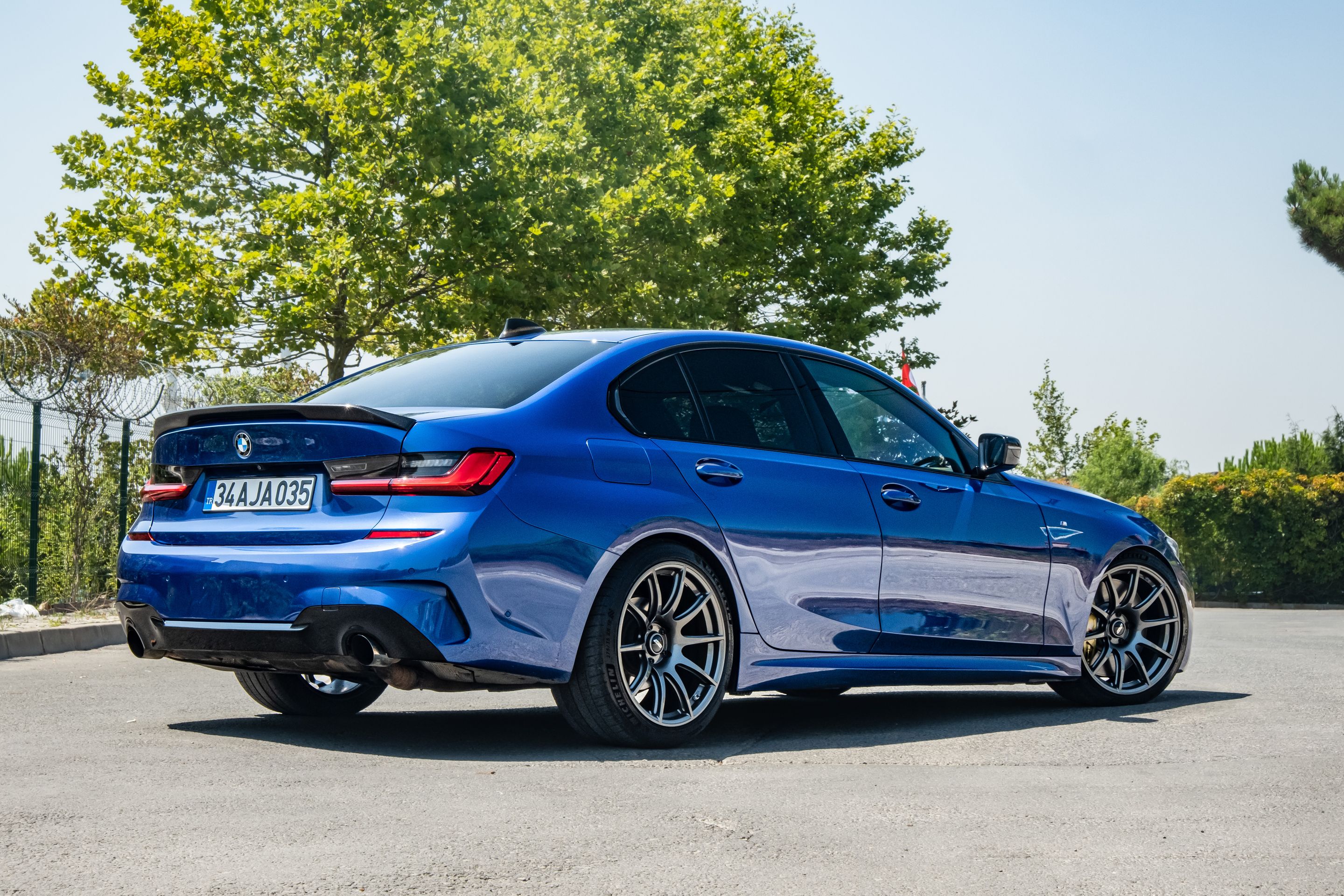 Blue BMW G20 Sedan 3 Series with 19" SM-10 Apex wheels in Anthracite