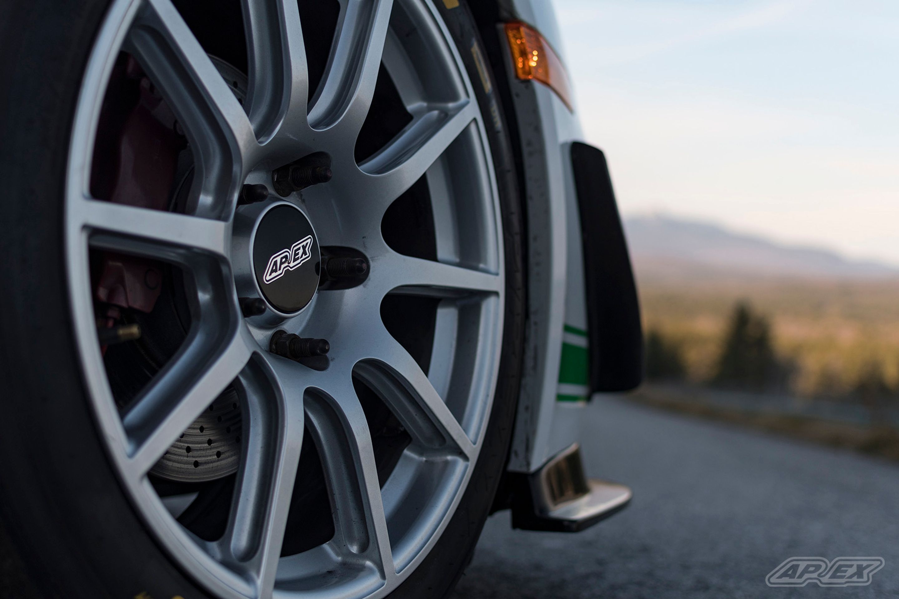 White Porsche 987 Cayman S with 18" SM-10 Apex wheels in Race Silver