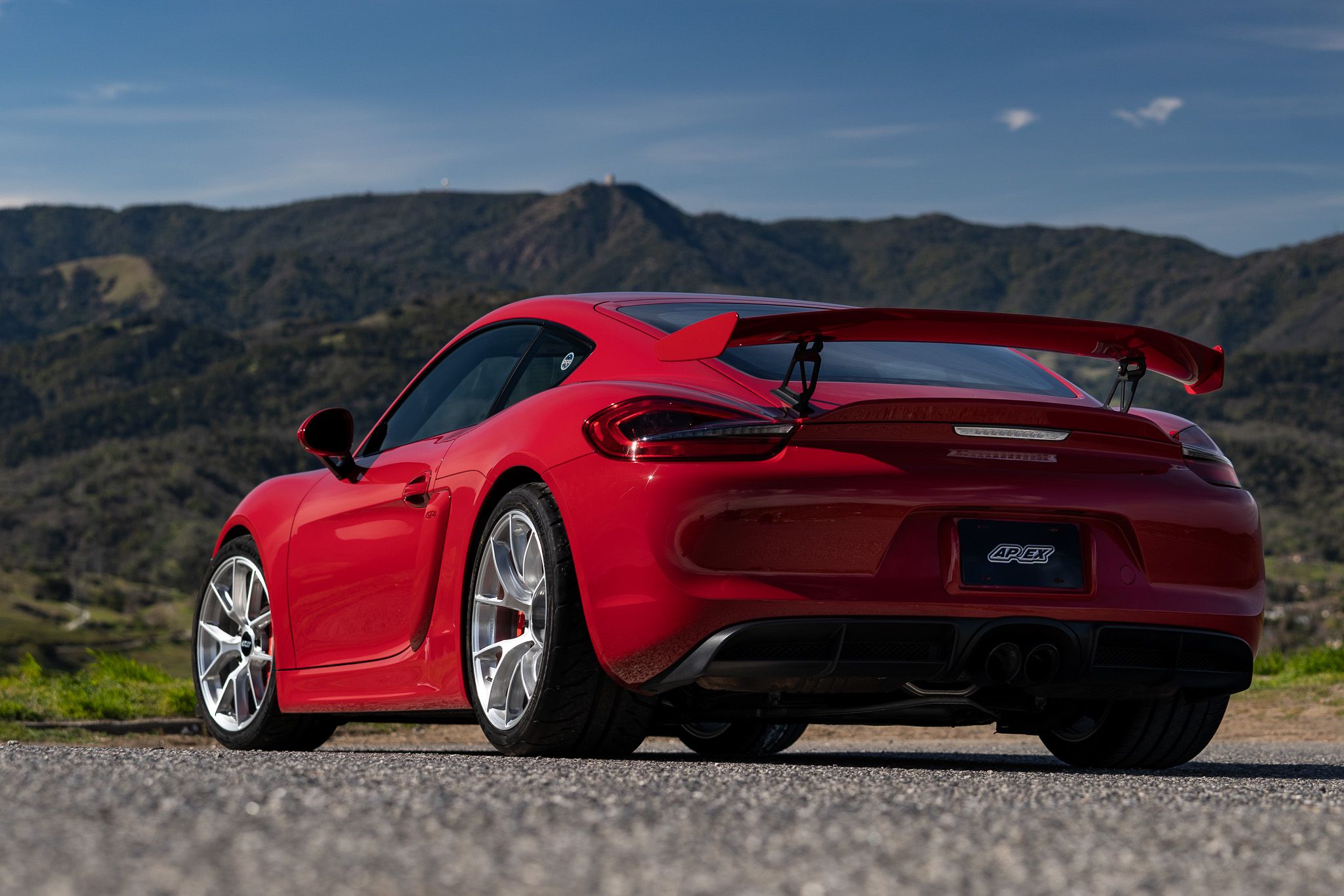 Red Porsche 981 Cayman GT4 with 19" VS-5RS Apex wheels in Brushed Clear