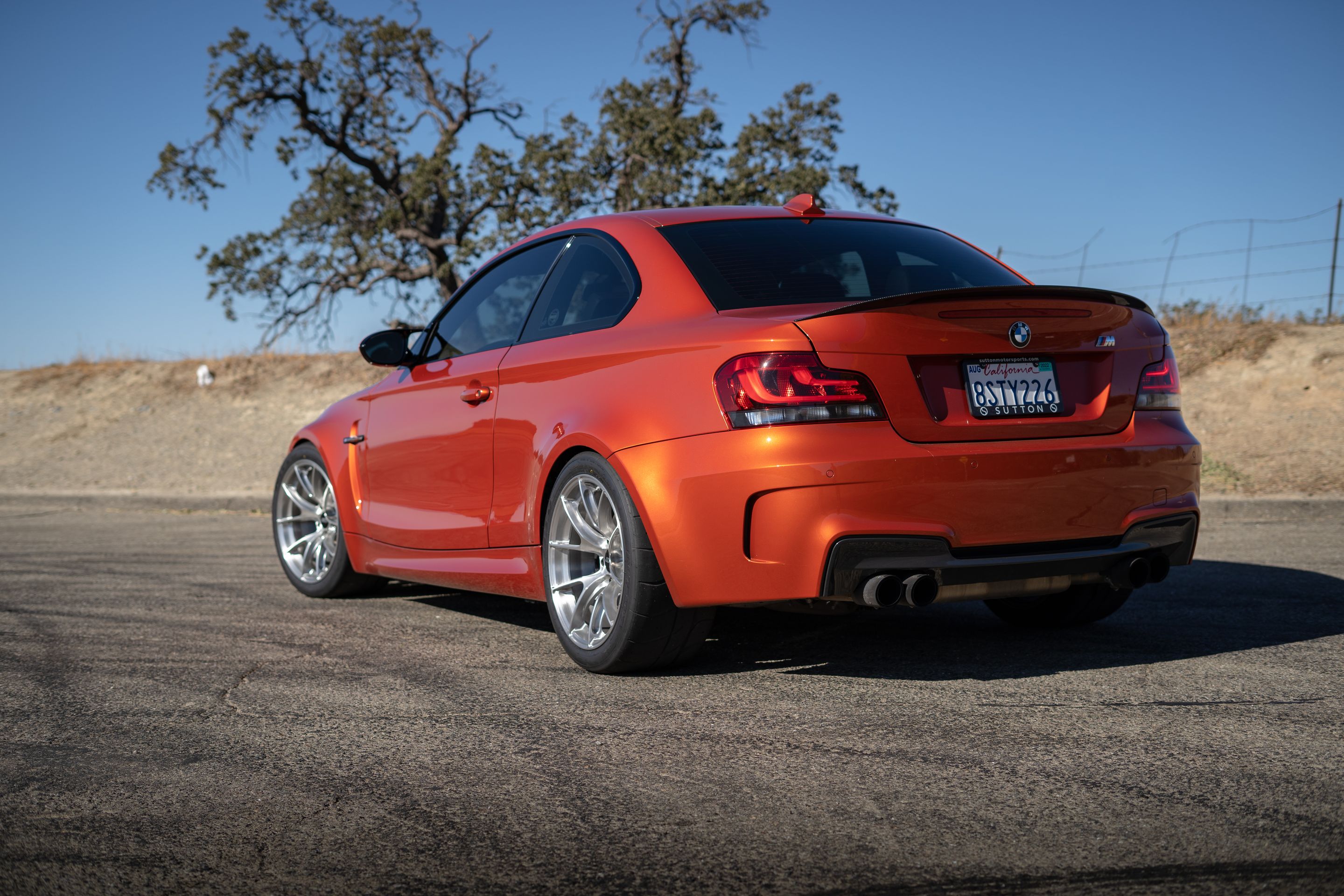 Orange BMW E82 1M with 18" VS-5RS Apex wheels in Brushed Clear