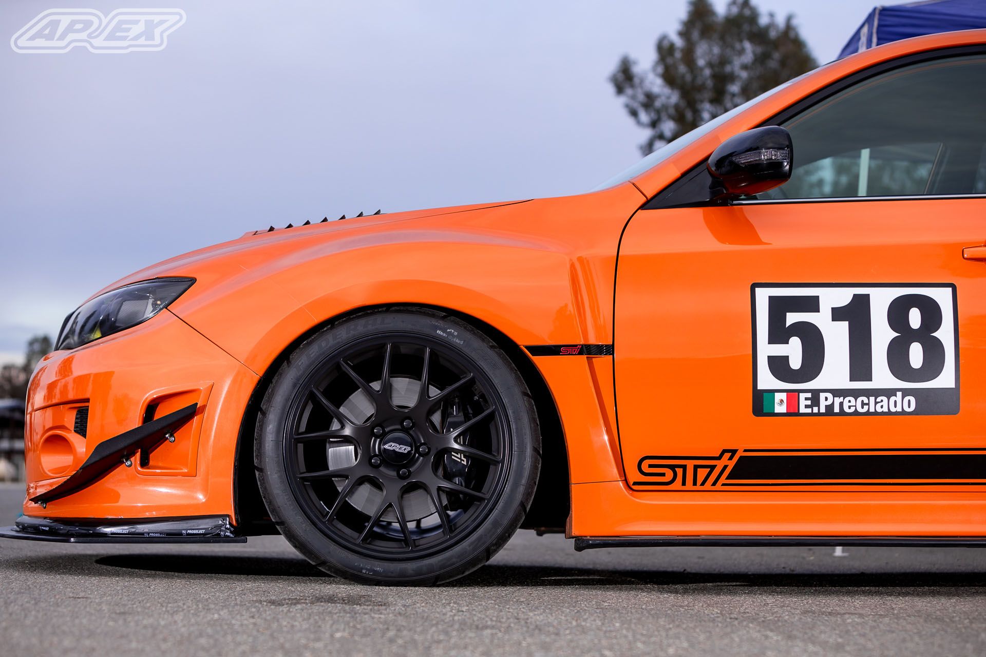 Orange Subaru GR WRX STI with 18" EC-7 Apex wheels in Satin Black