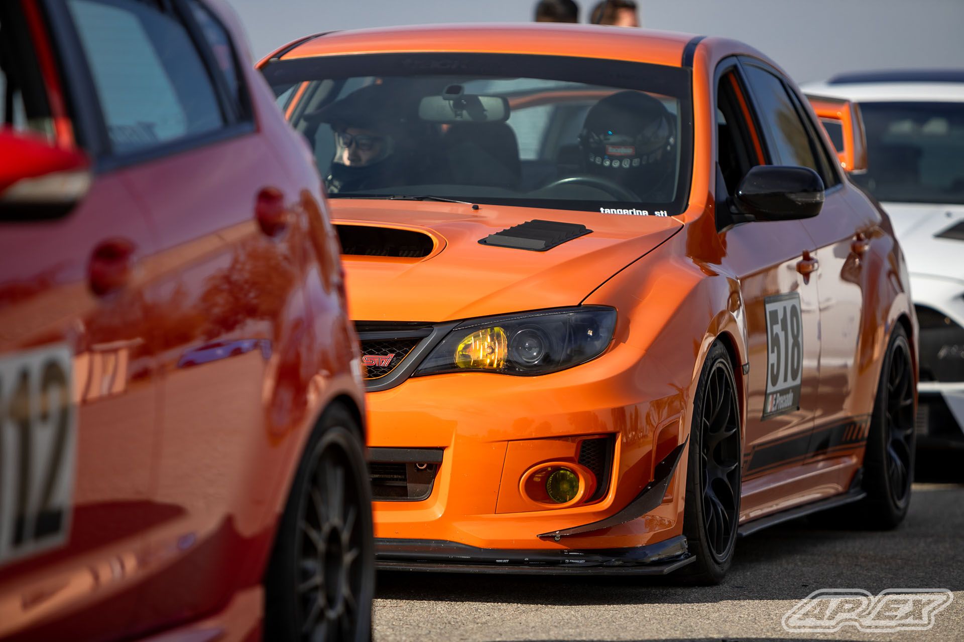 Orange Subaru GR WRX STI with 18" EC-7 Apex wheels in Satin Black
