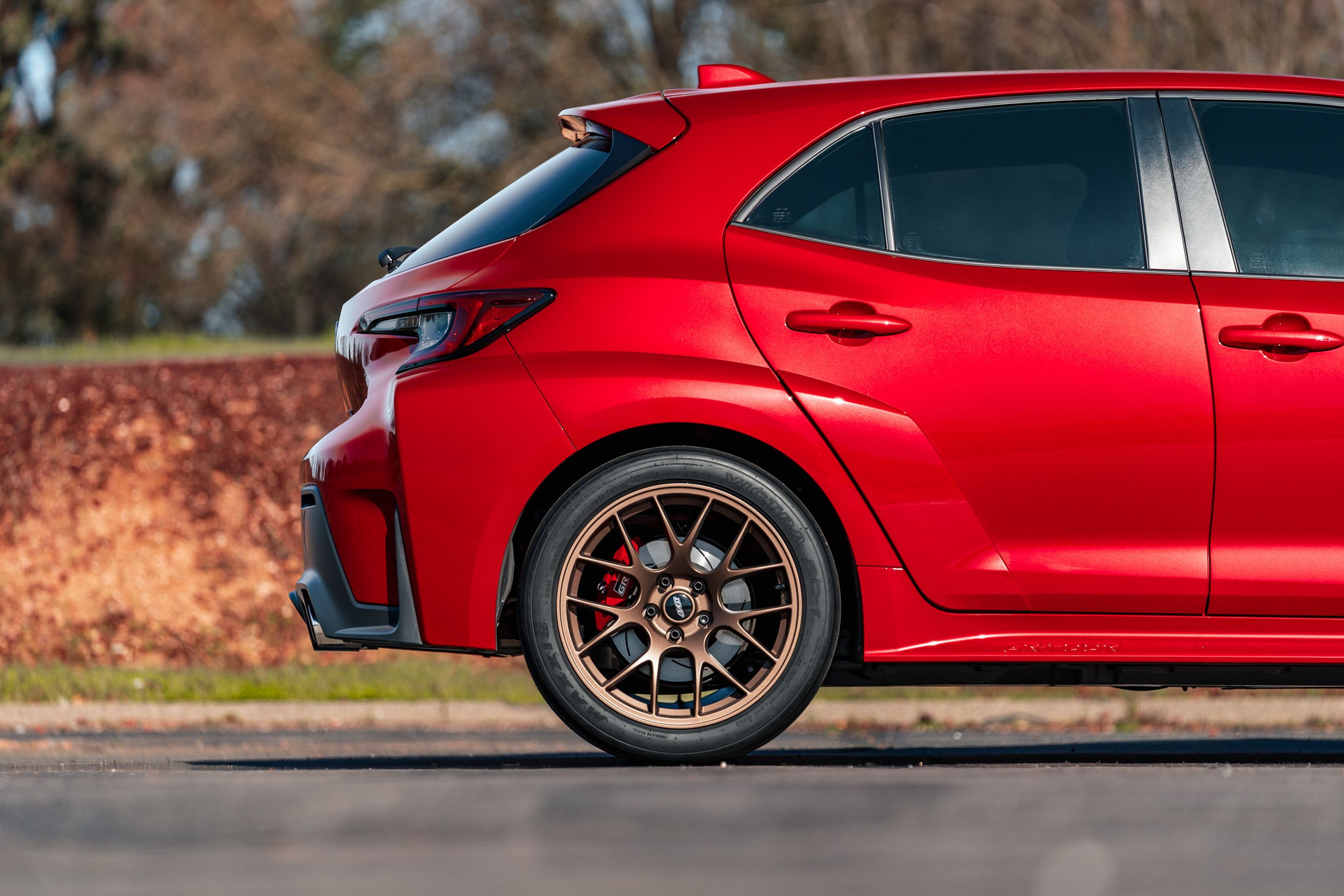Red Toyota GR Corolla with 18" EC-7 Apex wheels in Satin Bronze