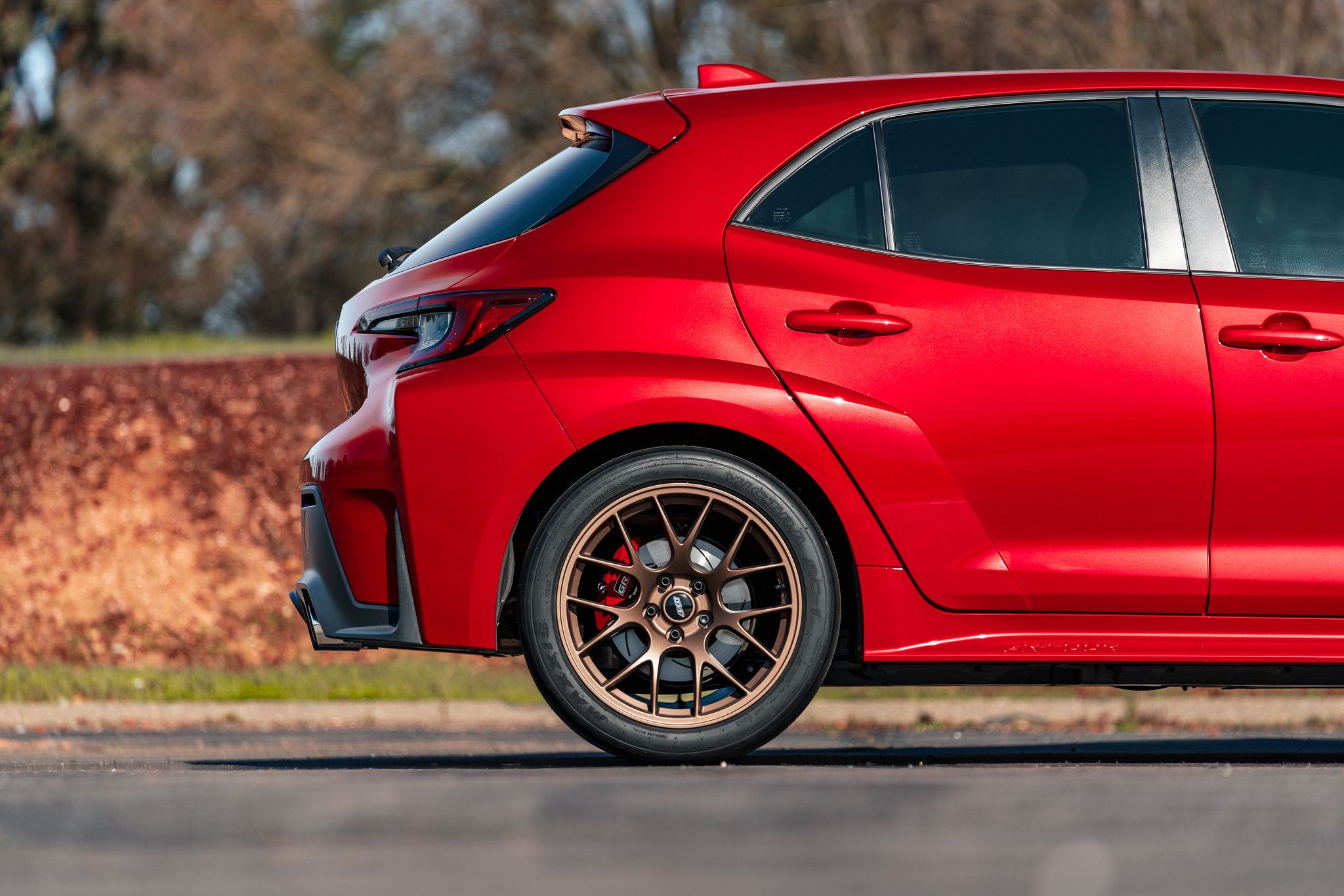 Red Toyota GR Corolla with 18" EC-7 Apex wheels in Satin Bronze