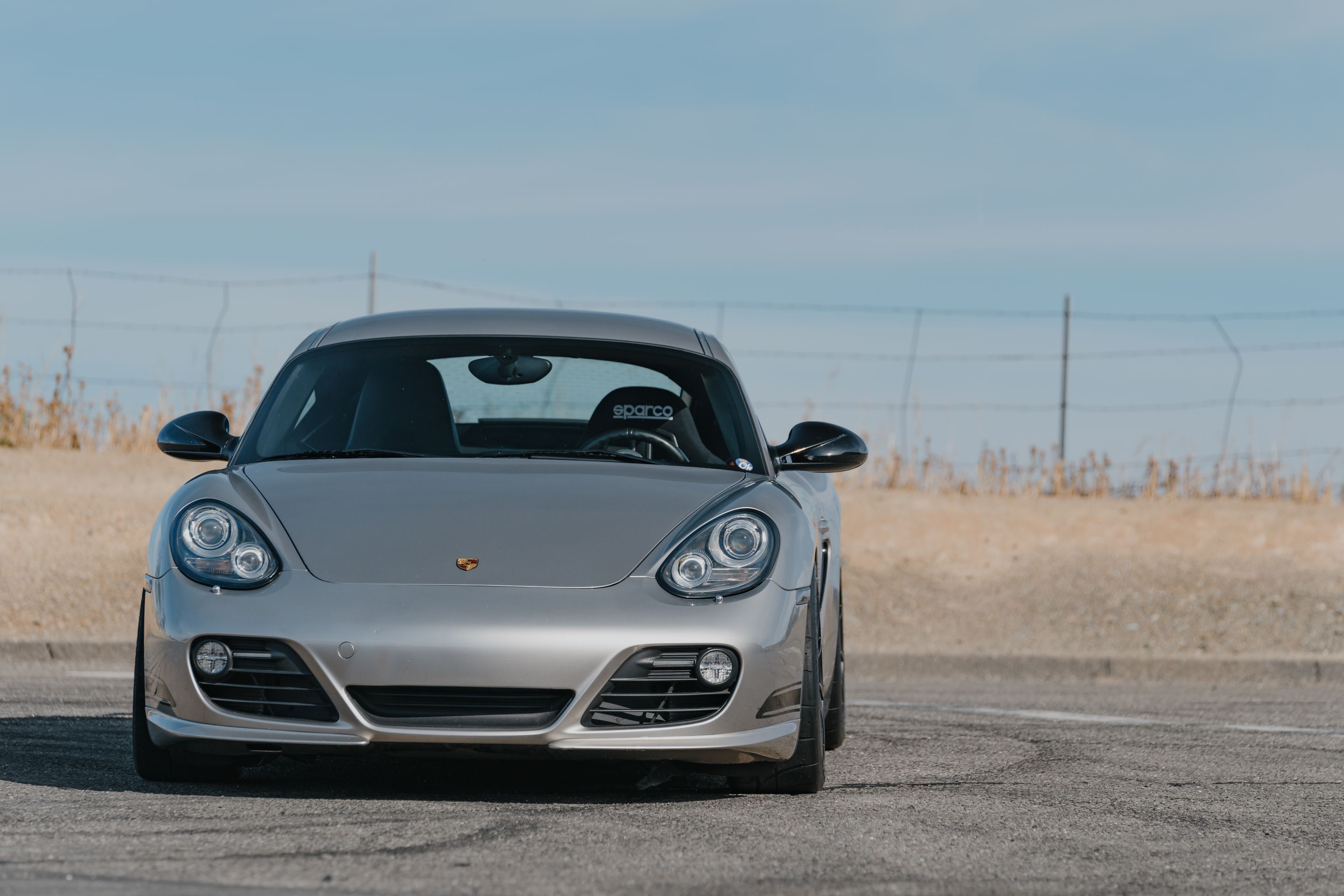 Silver Porsche 987 Cayman R with 18" SM-10RS Apex wheels in Satin Black