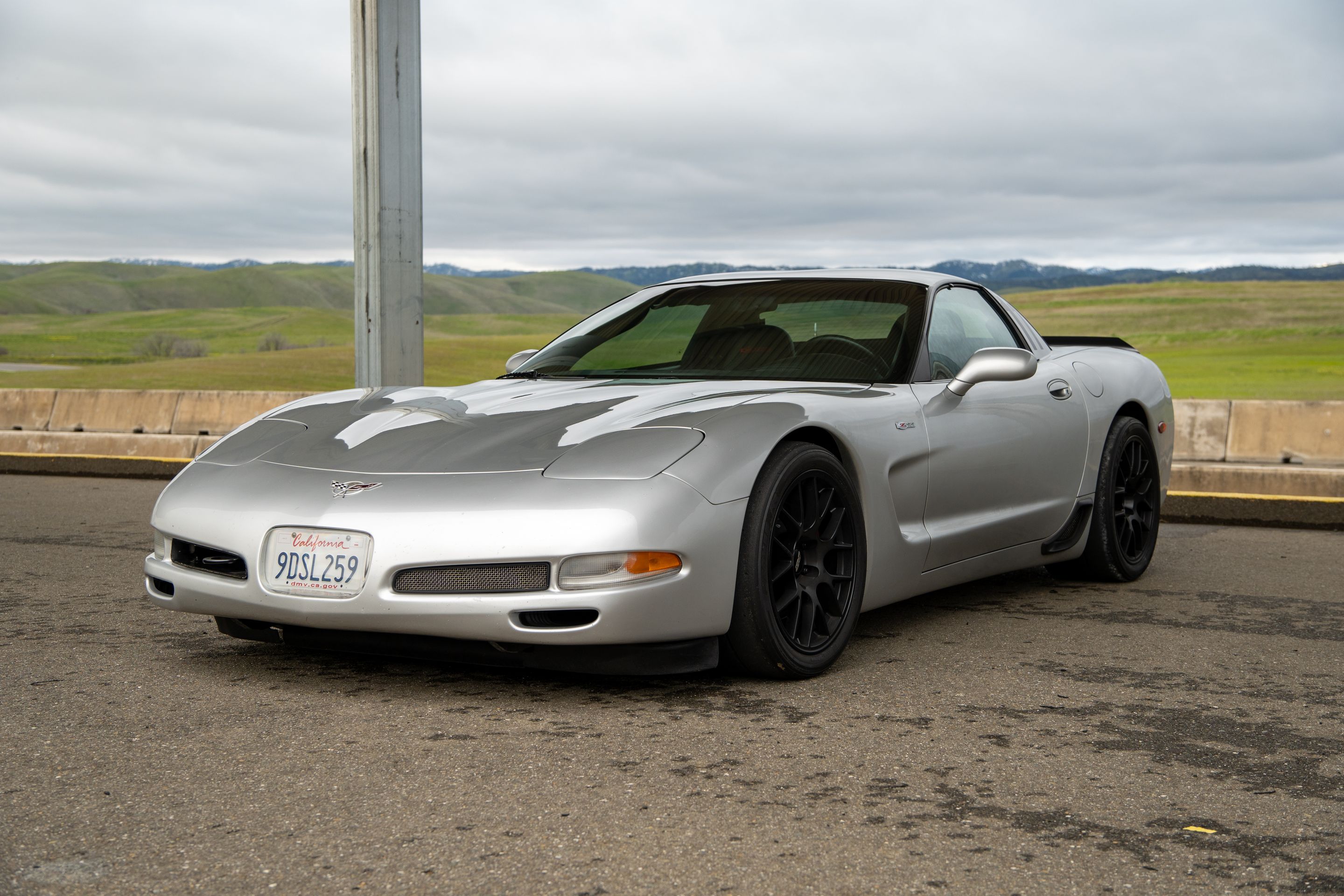 Silver Chevrolet C5 Corvette Z06 with 18" EC-7 Apex wheels in Satin Black