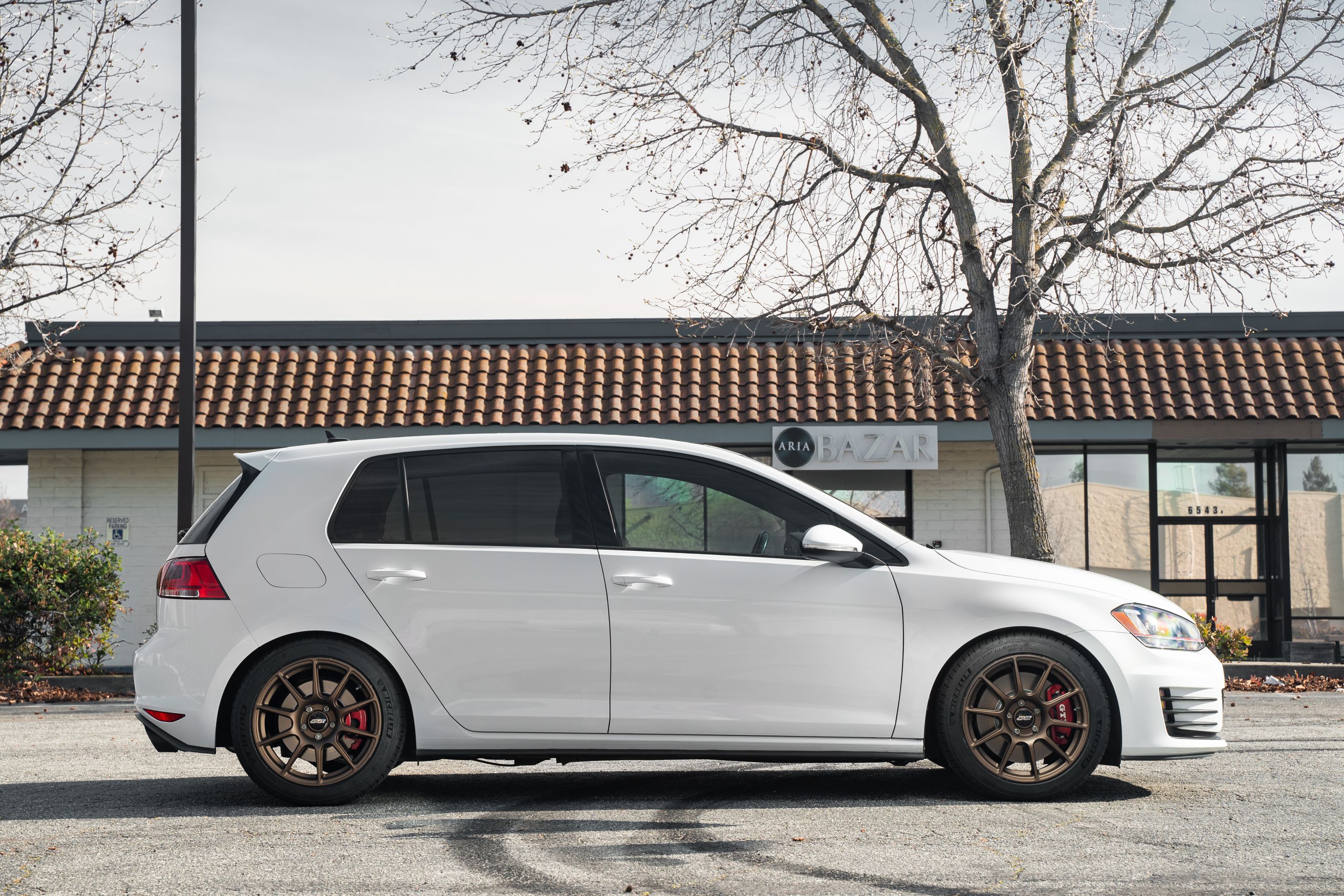 White VW MK7 GTI with 17" SM-10 Apex wheels in Satin Bronze