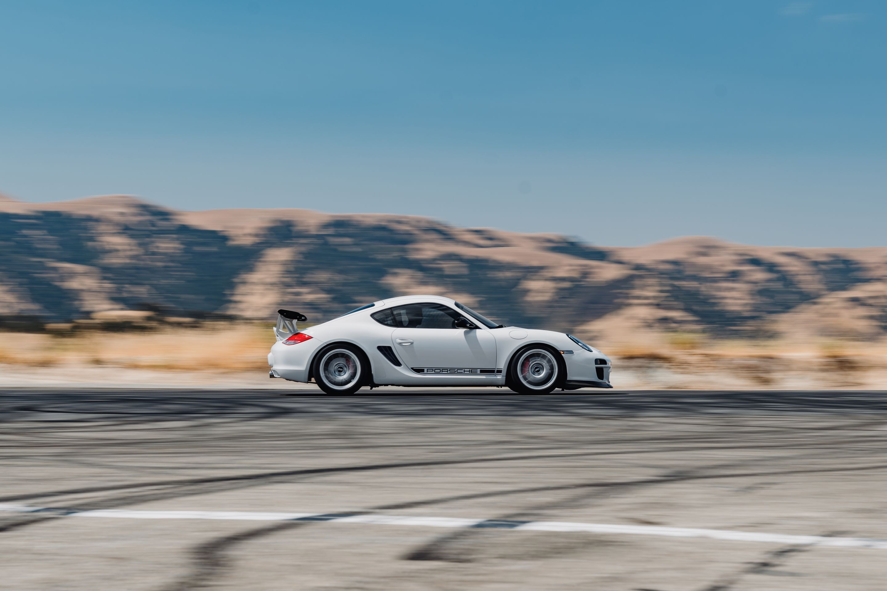 White Porsche 987 Cayman R with 18" EC-7RS Apex wheels in Race Silver