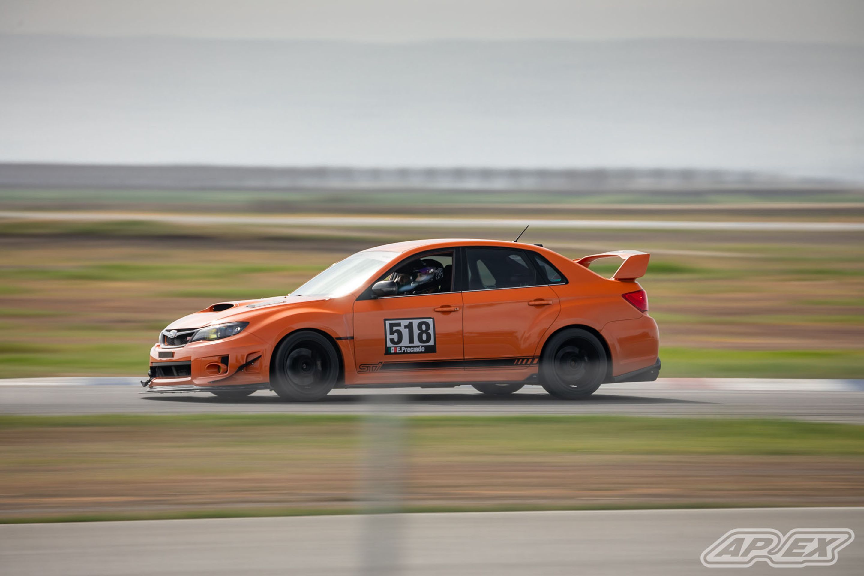 Orange Subaru GR WRX STI with 18" EC-7 Apex wheels in Satin Black