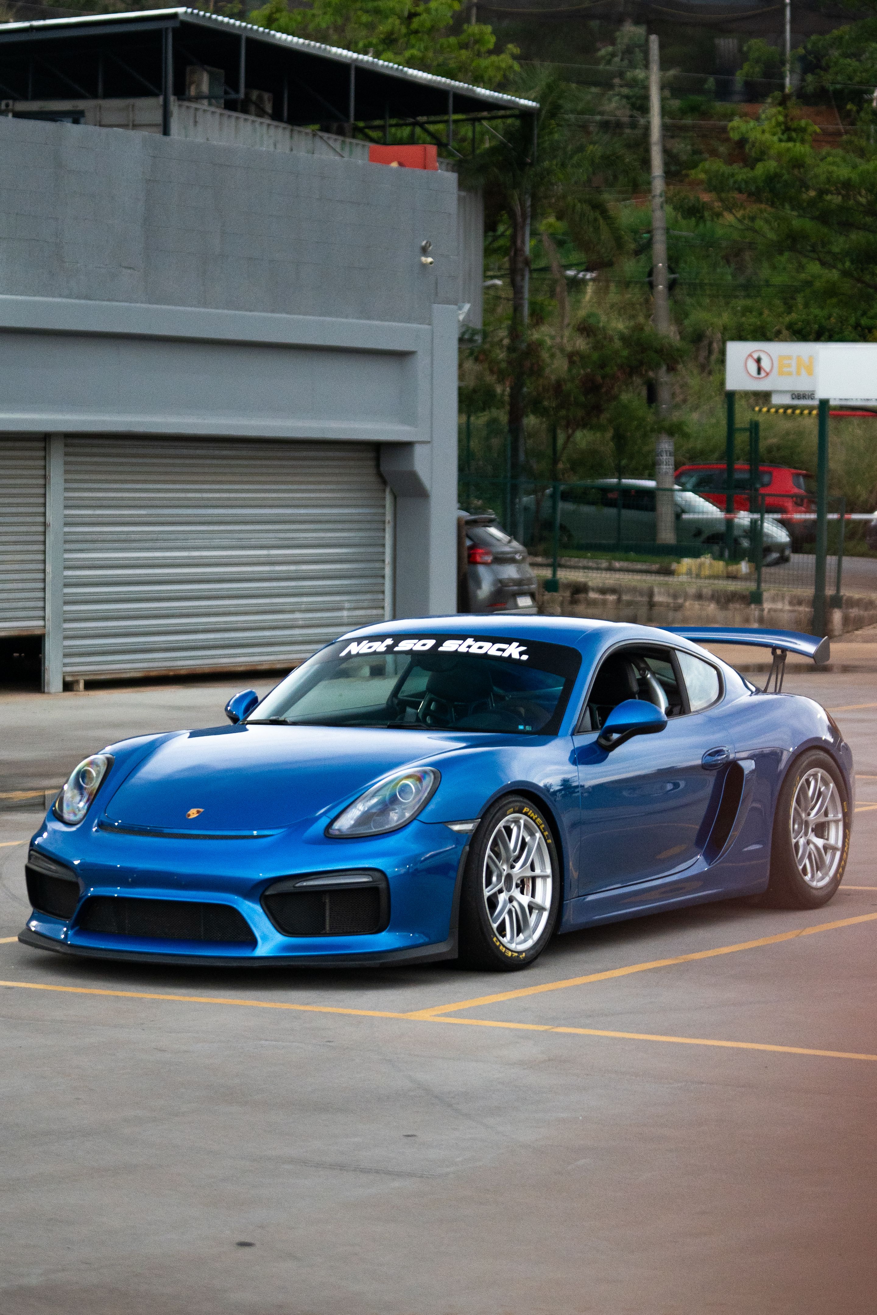 Blue Porsche 981 Cayman GT4 with 18" VS-5RE Apex wheels in Race Silver