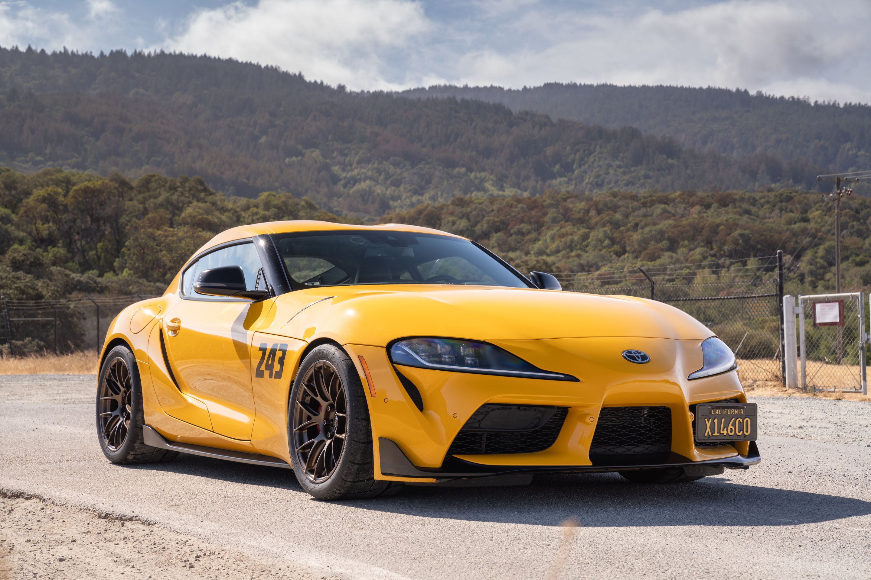 Yellow Toyota GR Supra with 18" EC-7RS Apex wheels in Satin Bronze