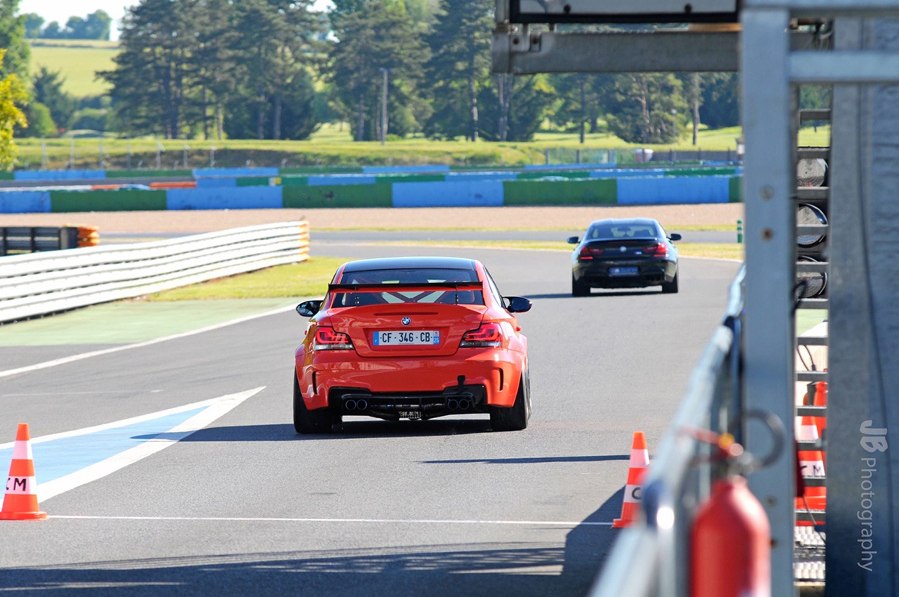 Orange BMW E82 1M with 18" EC-7 Apex wheels in Satin Black