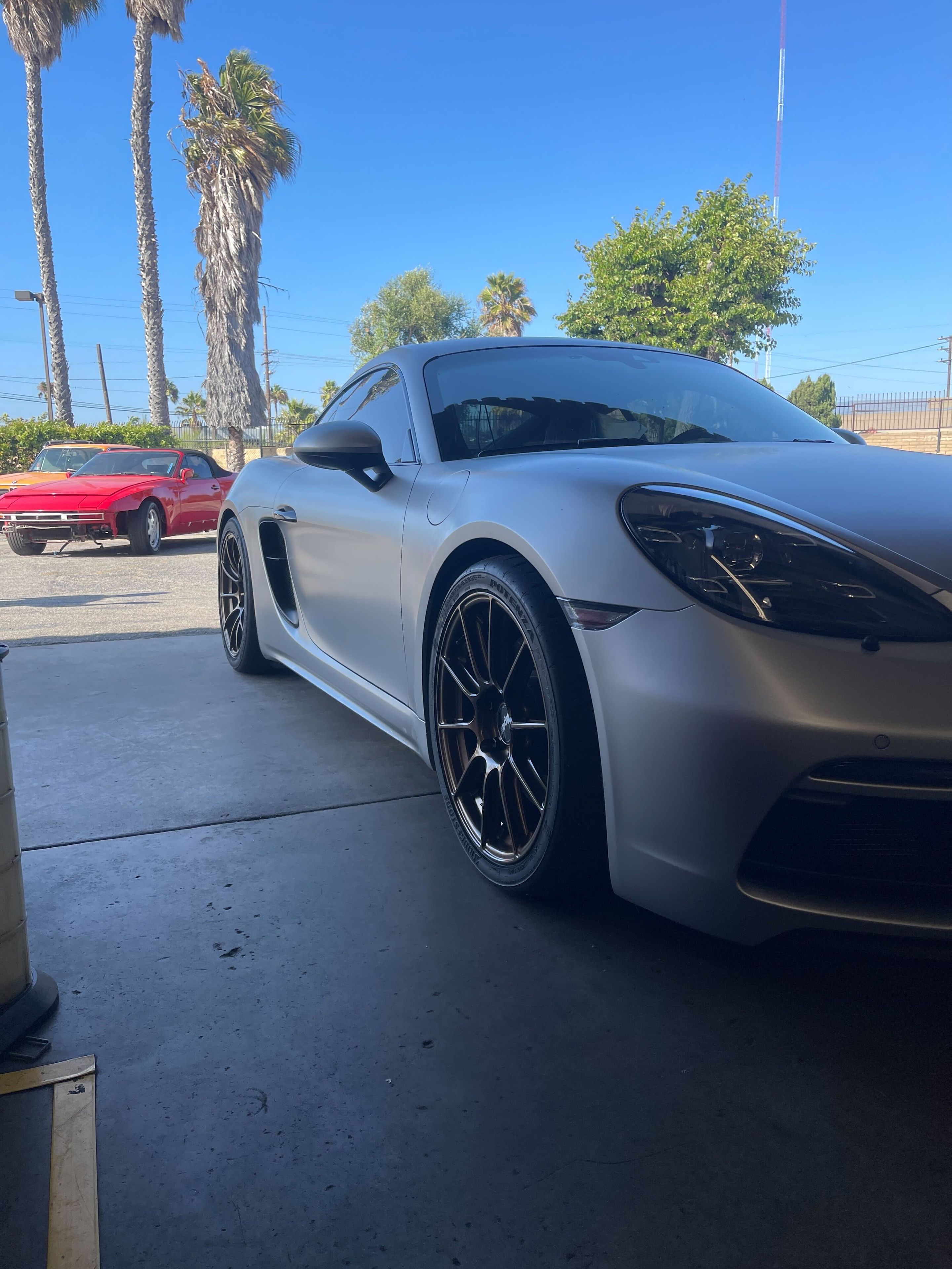 Silver Porsche 718 Cayman GTS 4.0L with 19" SM-10RS Apex wheels in Satin Bronze