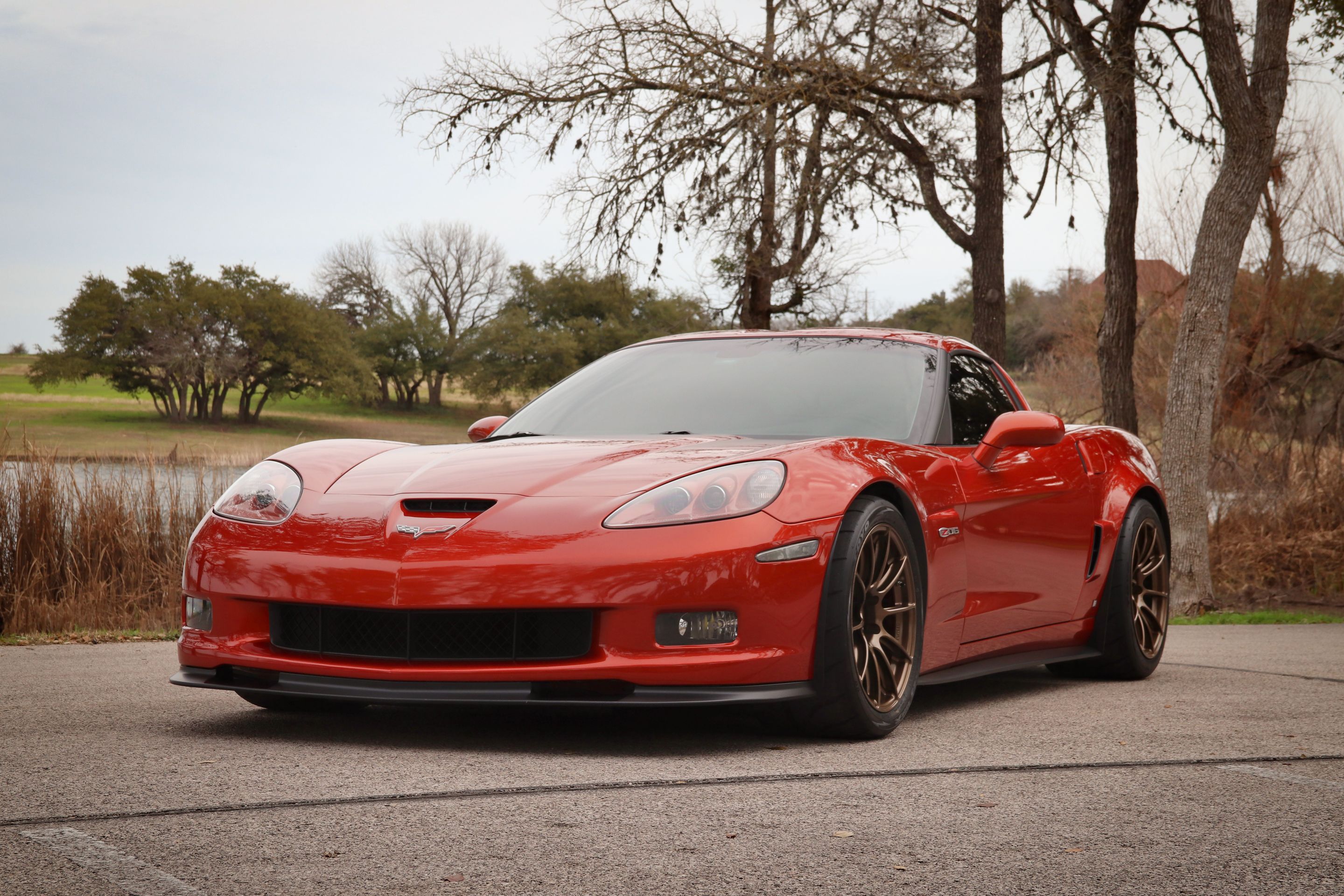 Red Chevrolet C6 Corvette Z06 with 18" SM-10RS Apex wheels in Satin Bronze