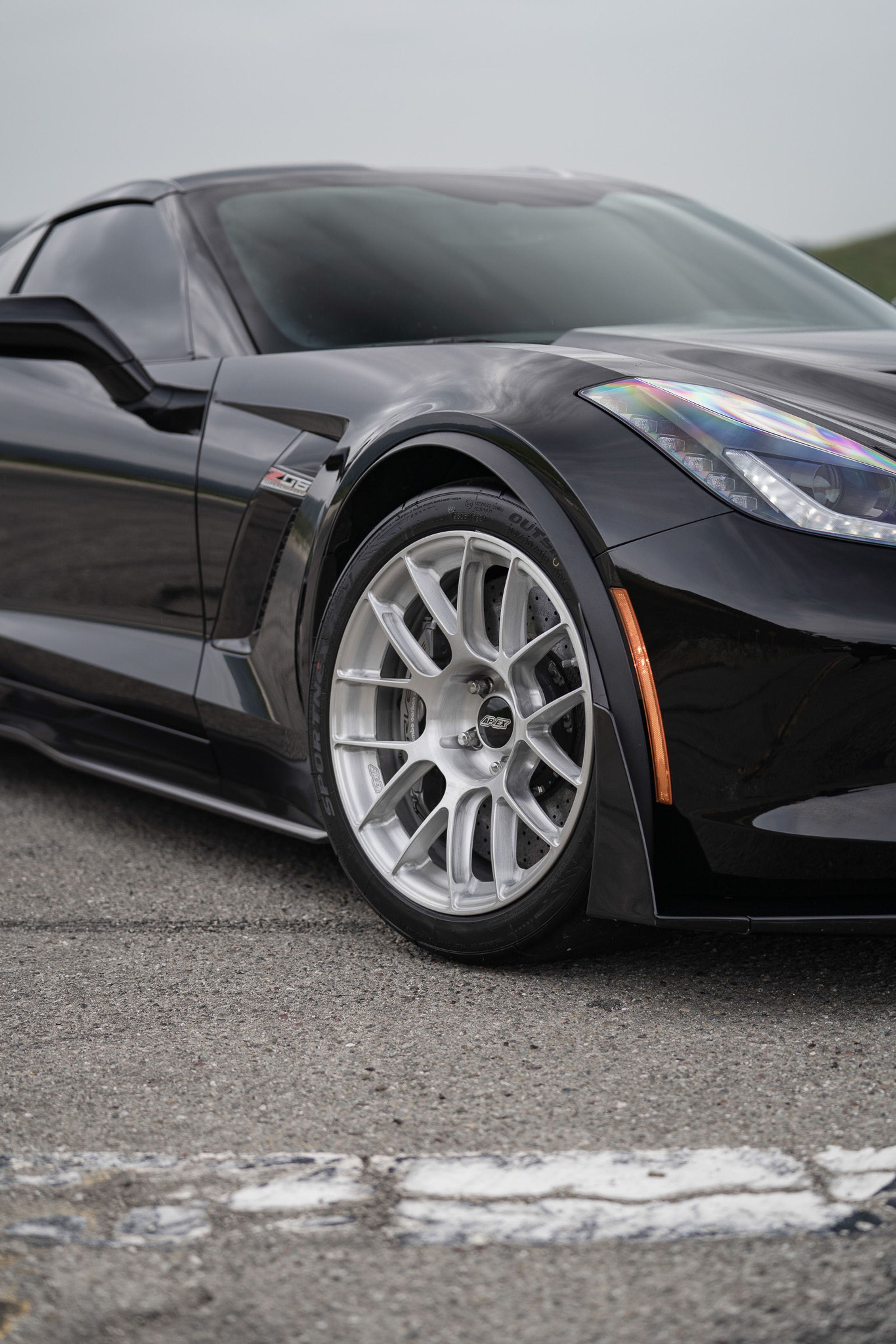 Black Chevrolet C7 Corvette Z06 with 18"/19" EC-7RS Apex wheels in Brushed Clear
