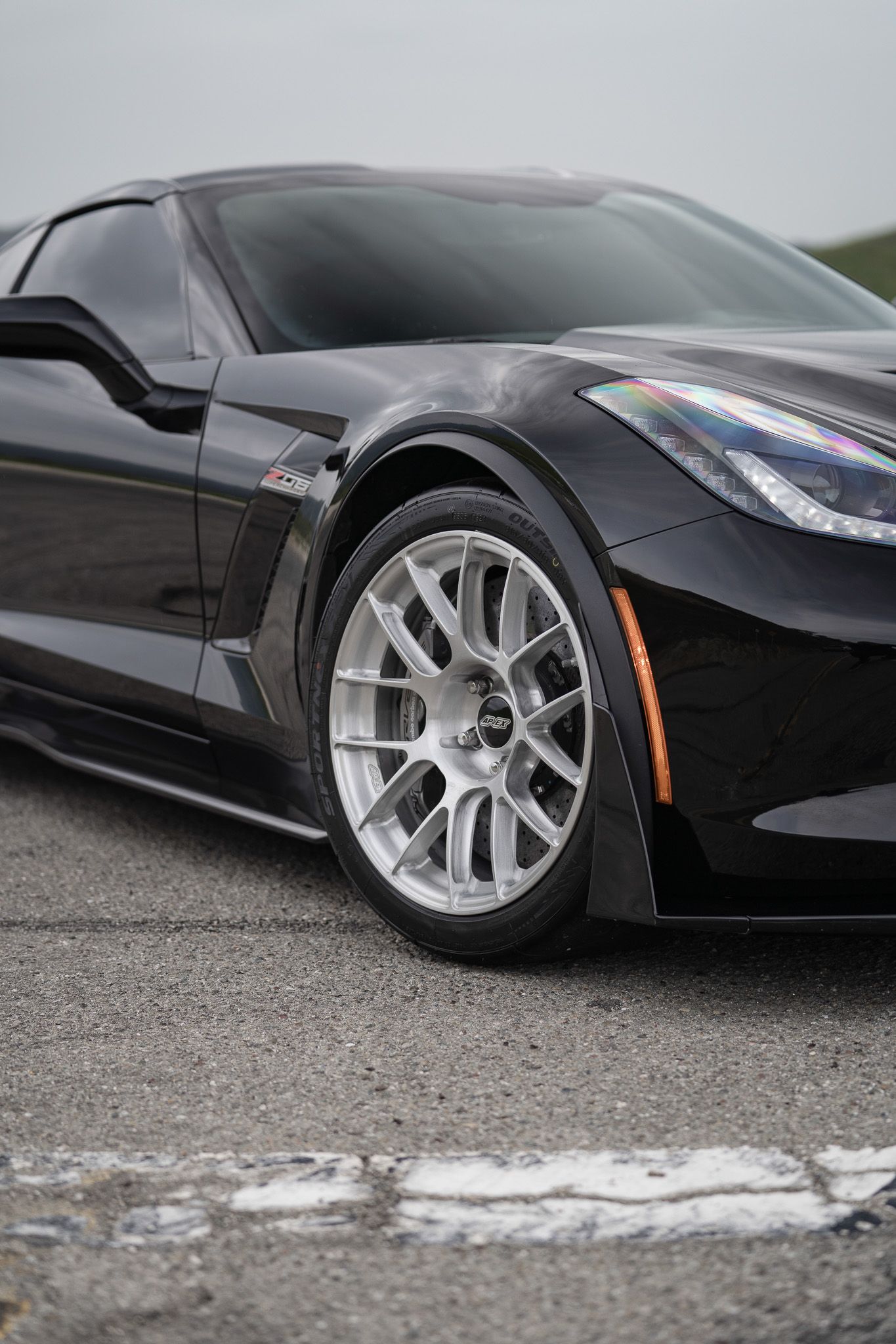 Black Chevrolet C7 Corvette Z06 with 18"/19" EC-7RS Apex wheels in Brushed Clear