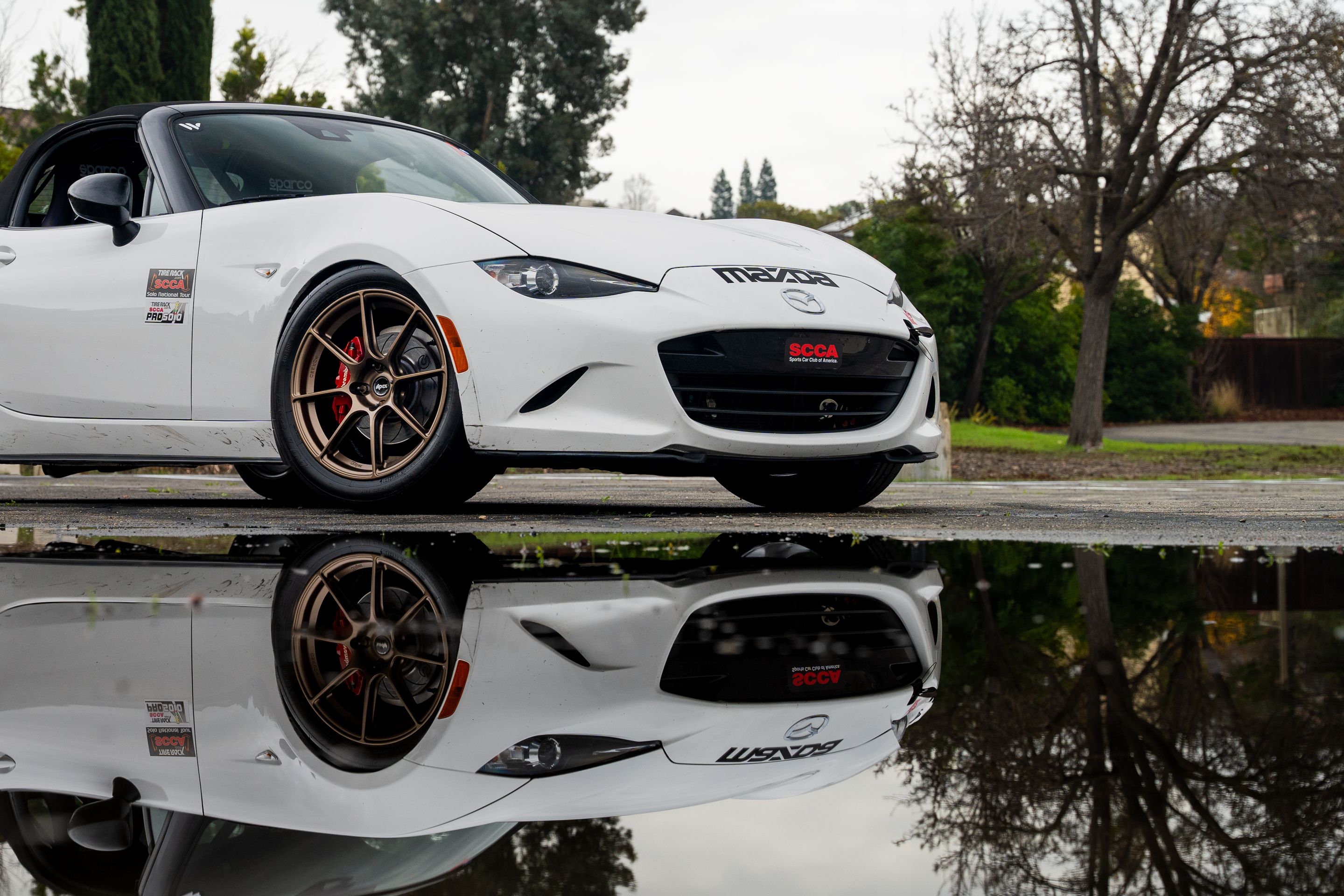 White Mazda ND MX-5 Miata with 17" SM-8RS Apex wheels in Satin Bronze