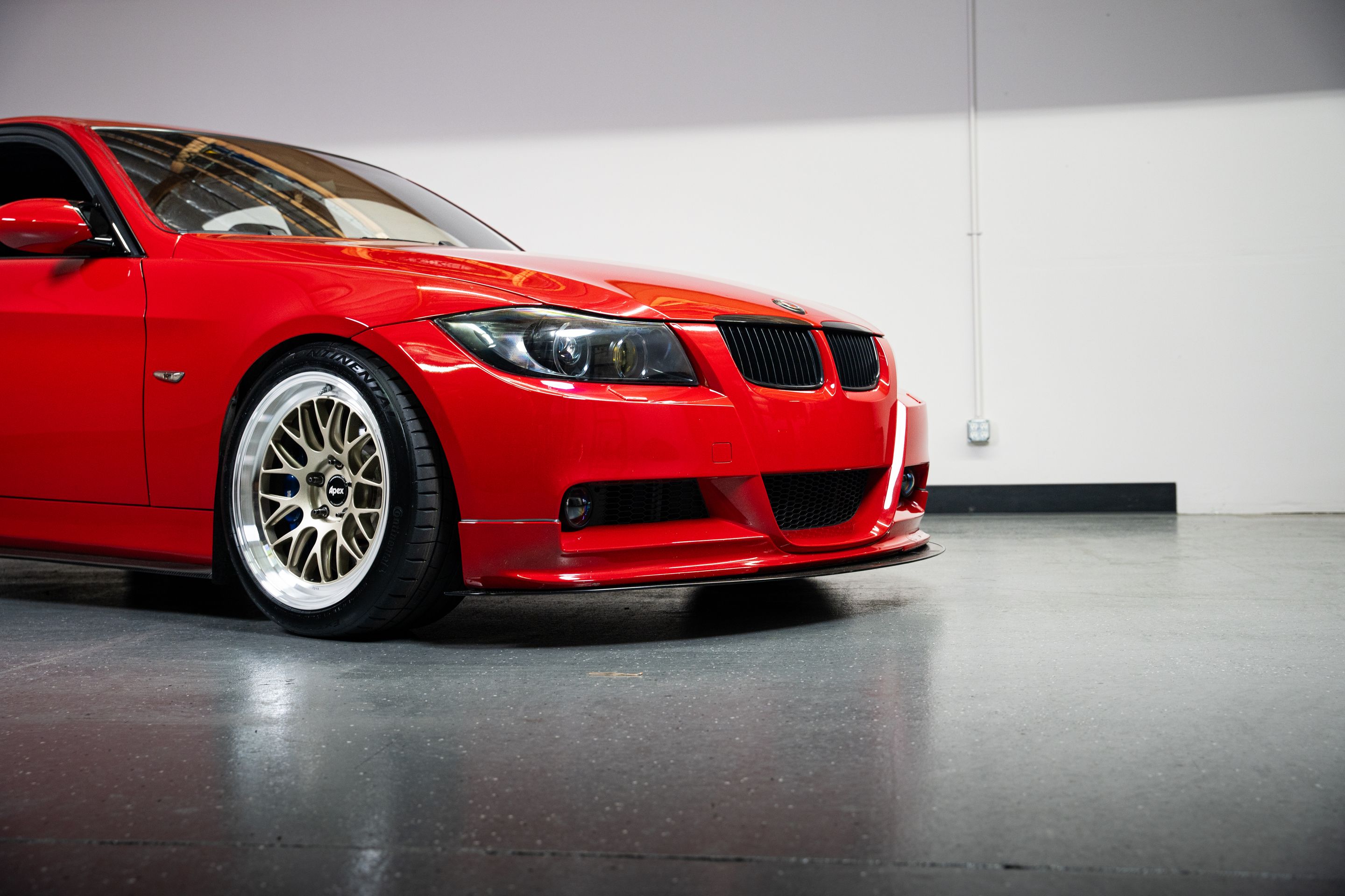 Red BMW E90 Sedan 3 Series with 18" ML-10RT Apex wheels in Machined Lip Gloss Motorsport Gold