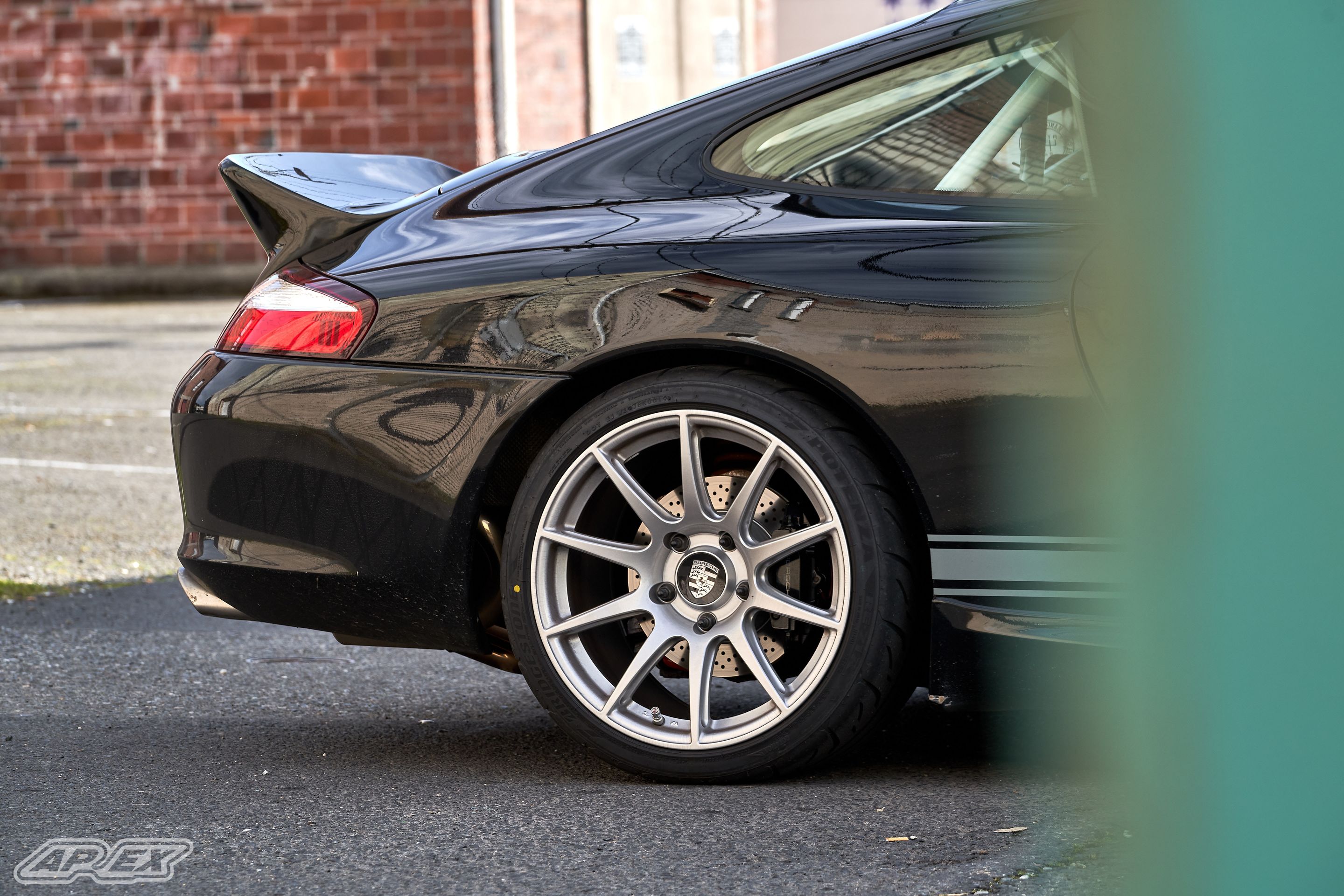 Black Porsche 911 996 Carrera with 18" SM-10 Apex wheels in Race Silver