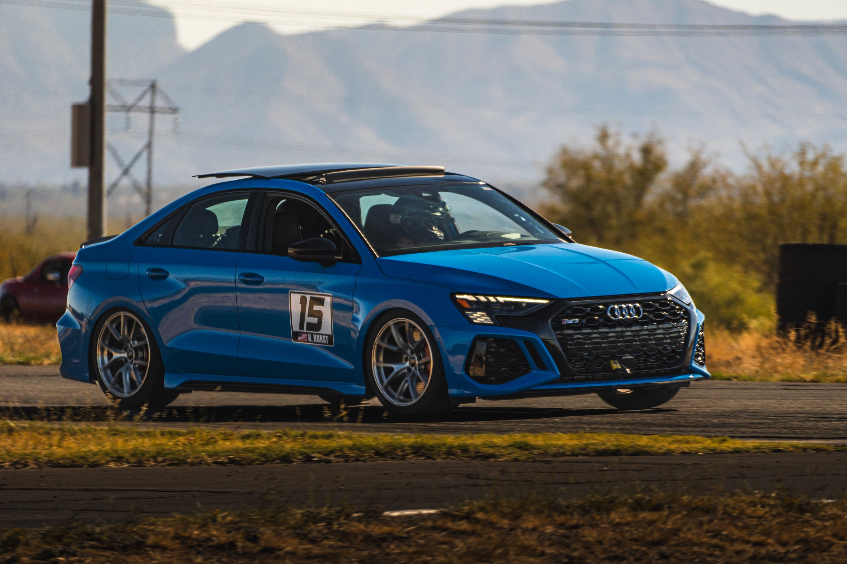 Blue Audi 8Y RS 3 with 18" VS-5RS Apex wheels in Brushed Clear