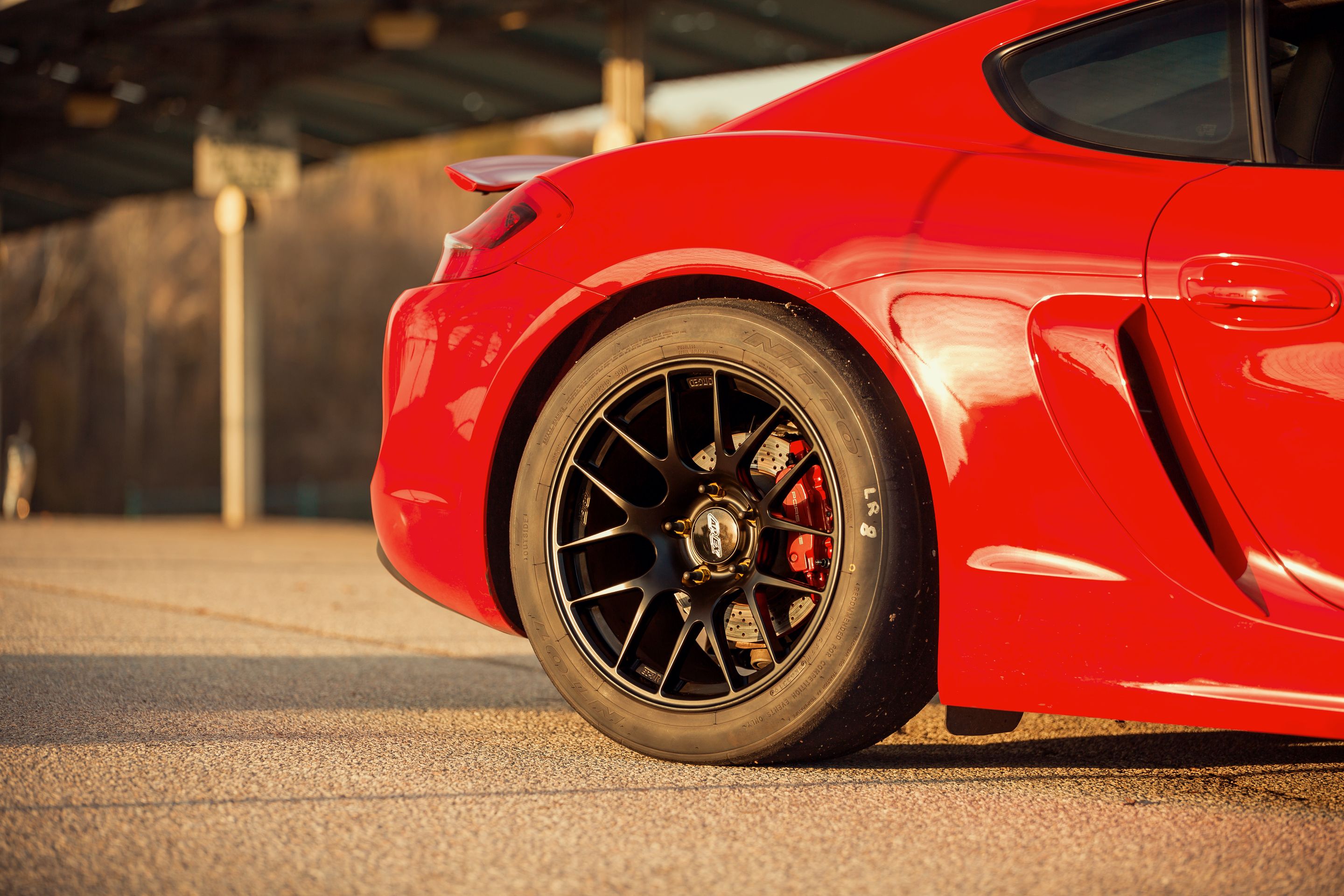 Red Porsche 981 Cayman S with 18" EC-7R Apex wheels in Satin Black