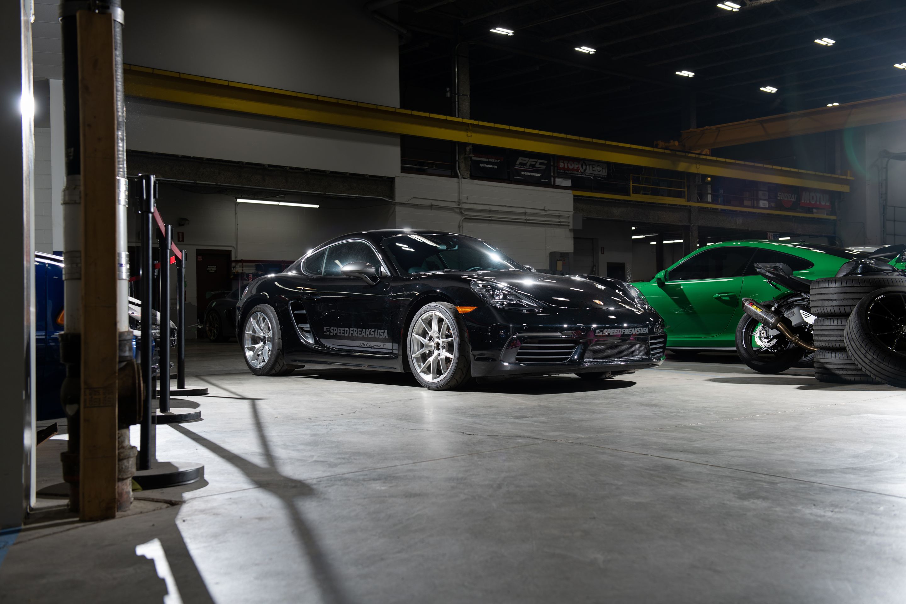Black Porsche 718 Cayman T with 18" VS-5RS Apex wheels in Brushed Clear