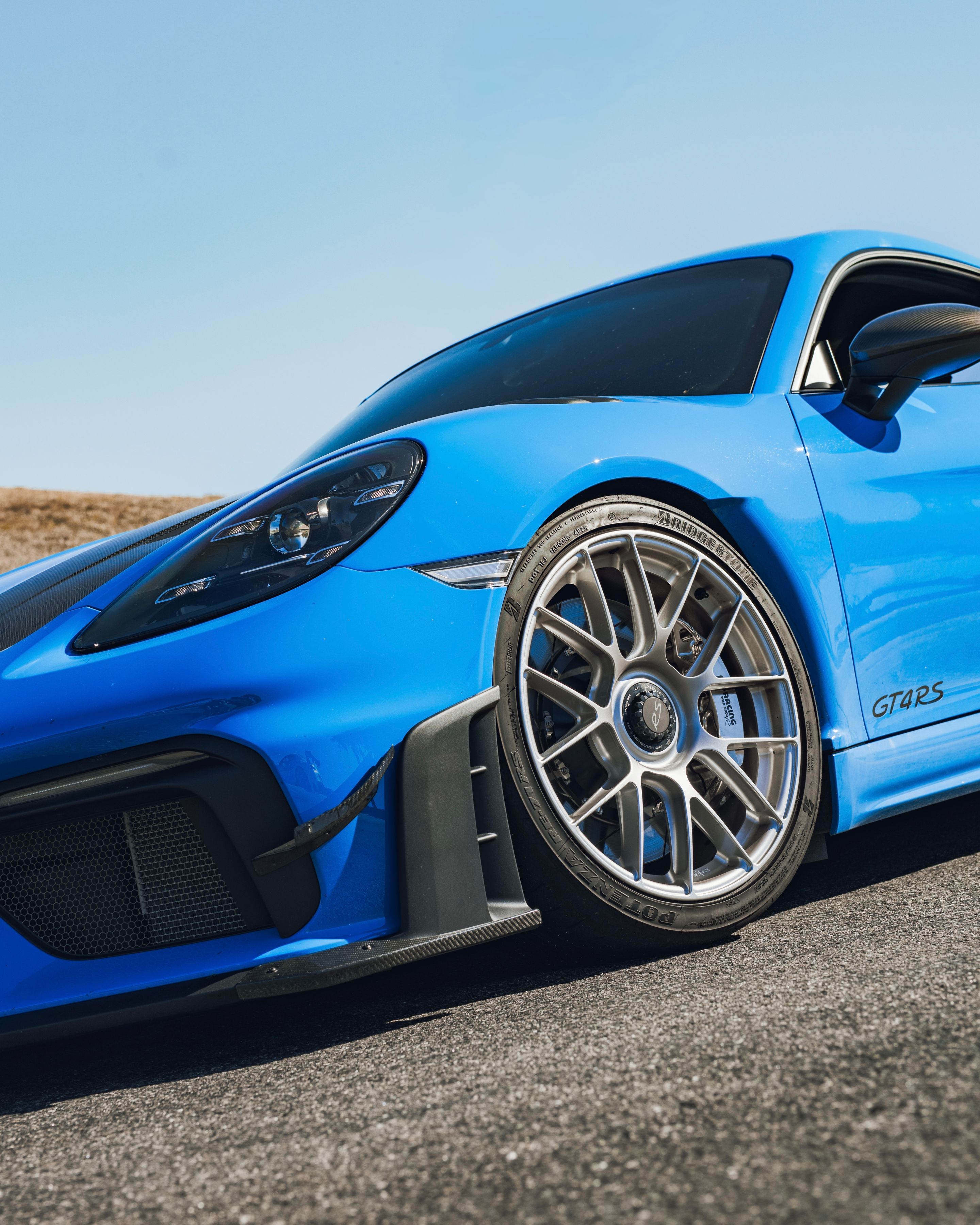 Blue Porsche 718 Cayman GT4 RS with 19" EC-7RS Apex wheels in Race Silver