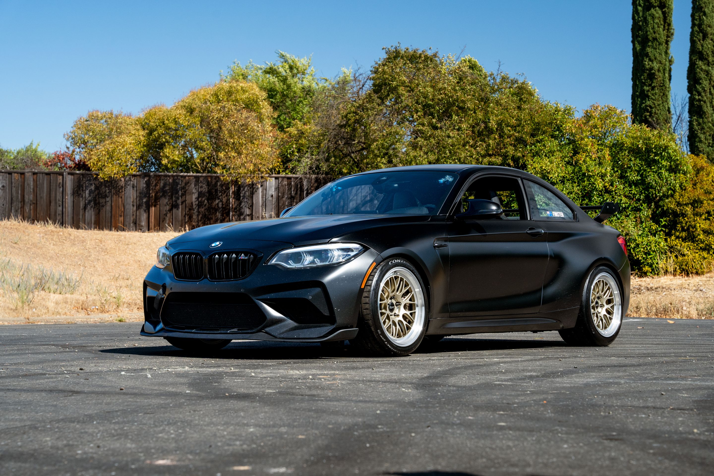 Black BMW F87 M2 with 18" ML-10RT Apex wheels in Machined Lip Gloss Motorsport Gold