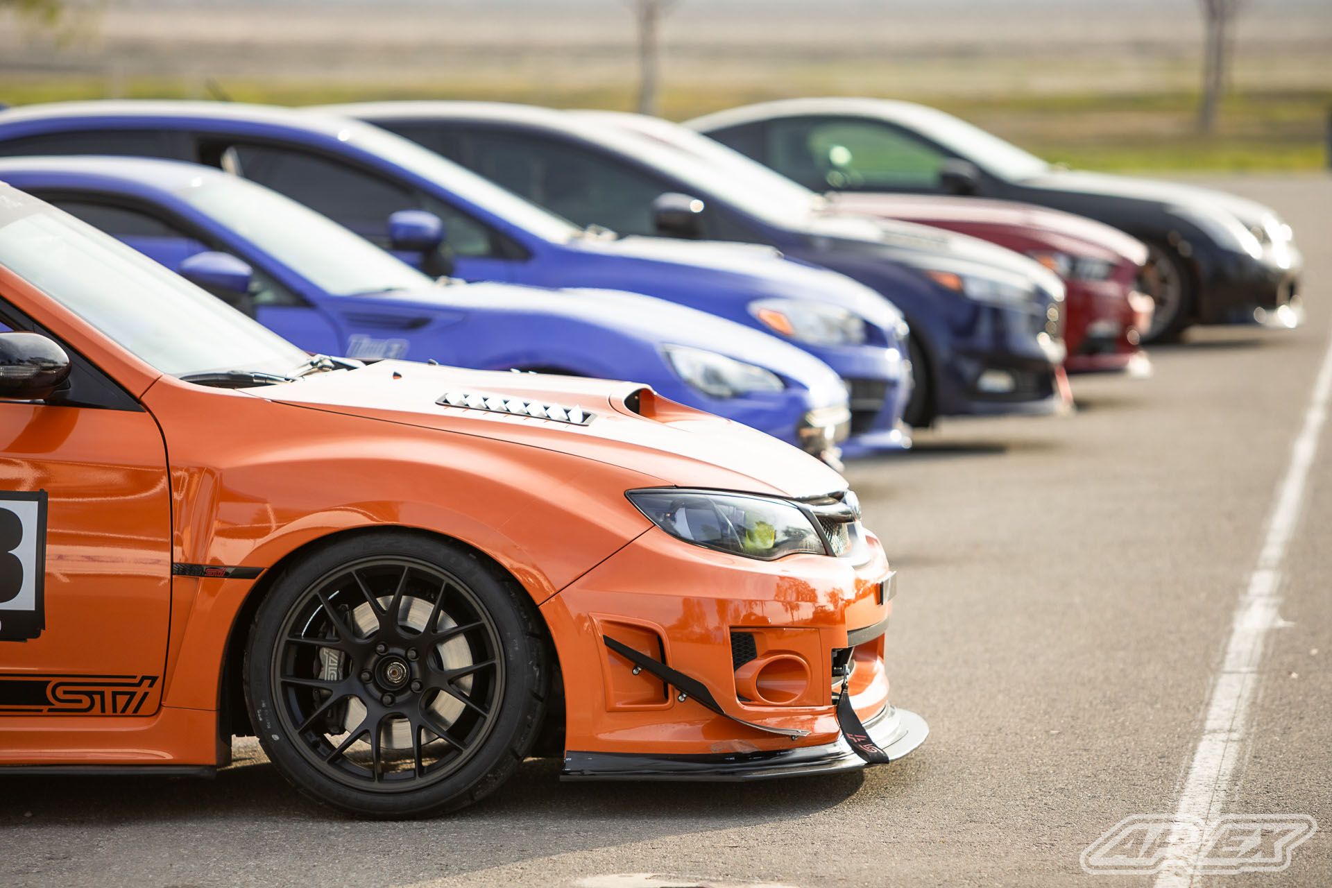 Orange Subaru GR WRX STI with 18" EC-7 Apex wheels in Satin Black