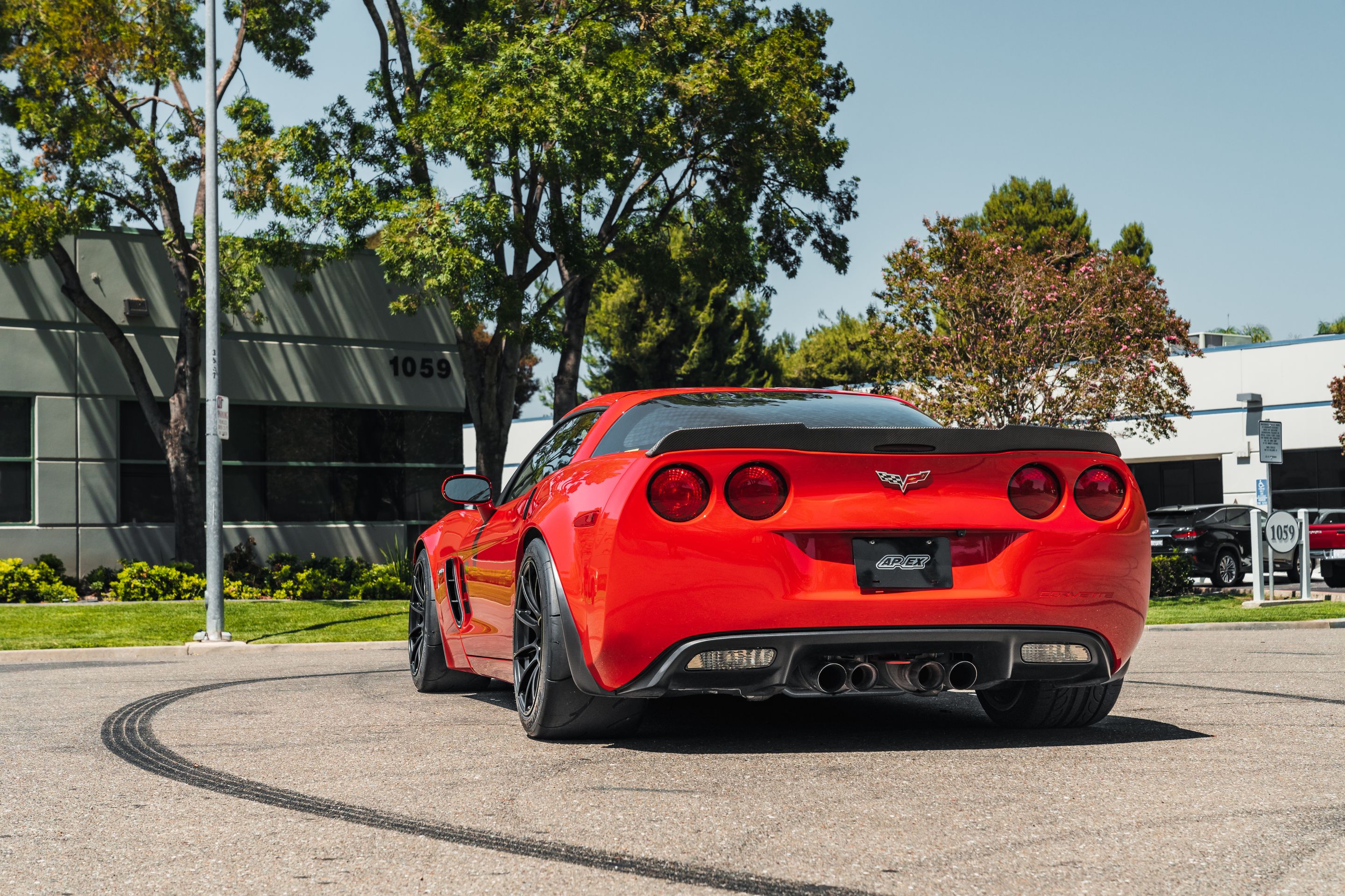 Red Chevrolet C6 Corvette Z06 with 18" SM-10RS Apex wheels in Satin Black