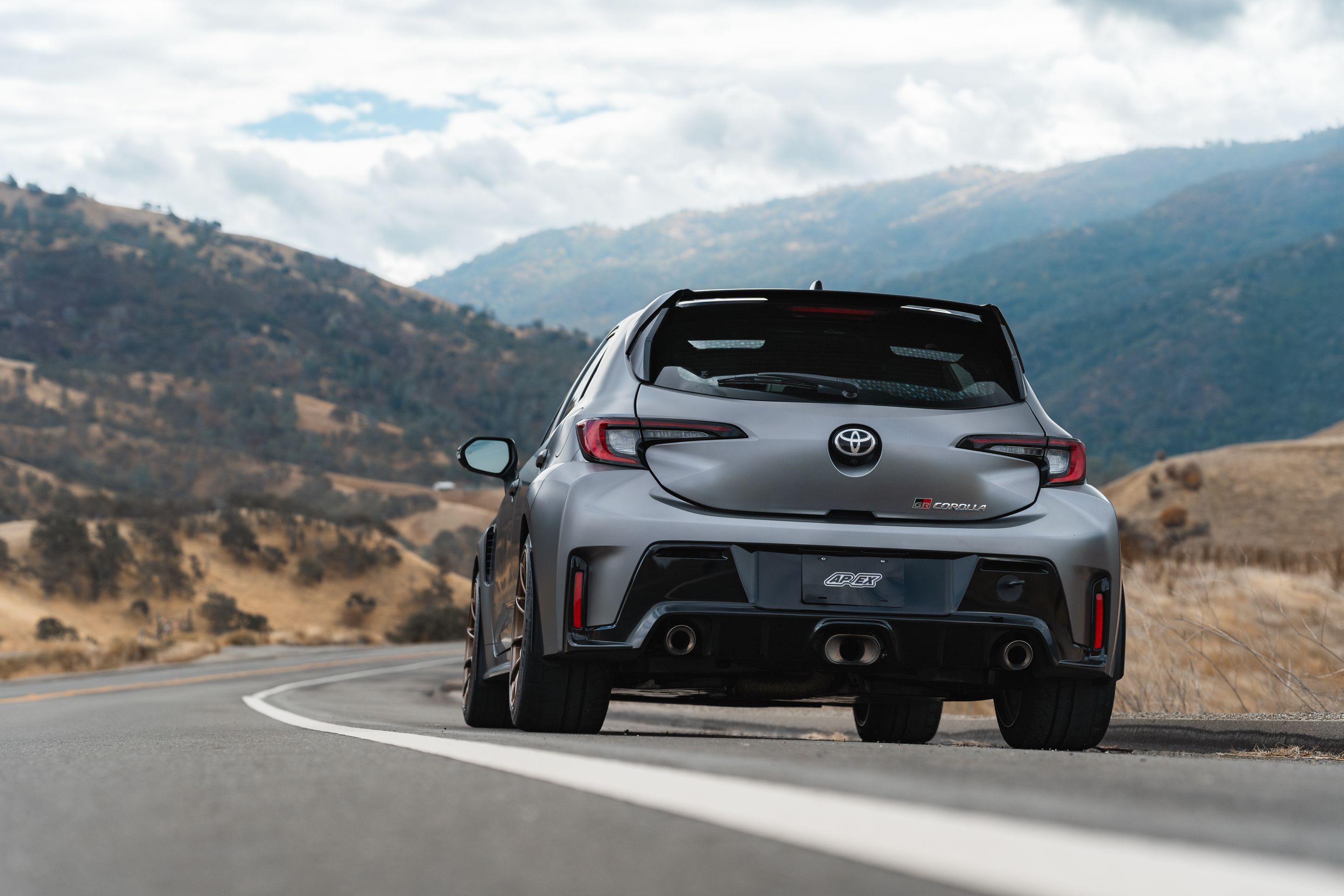 Grey Toyota GR Corolla with 18" SM-10RS Apex wheels in Satin Bronze
