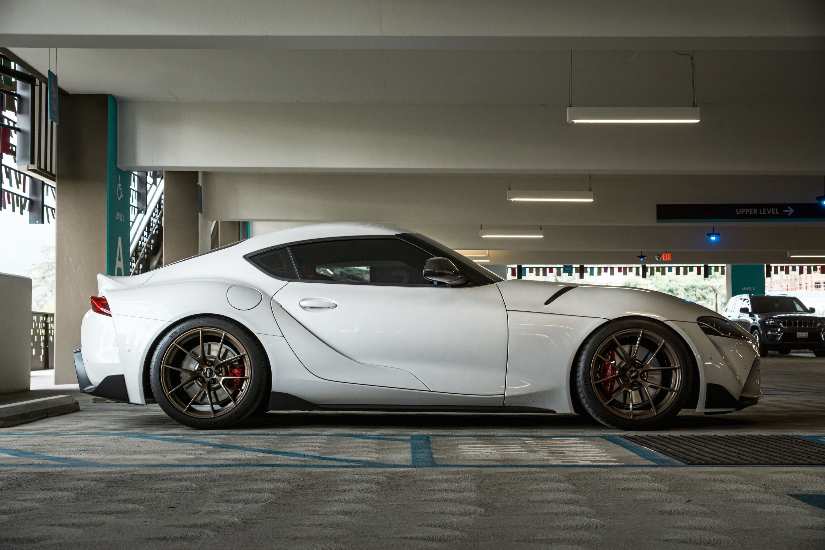 White Toyota GR Supra with 19" VS-5RS Apex wheels in Satin Bronze