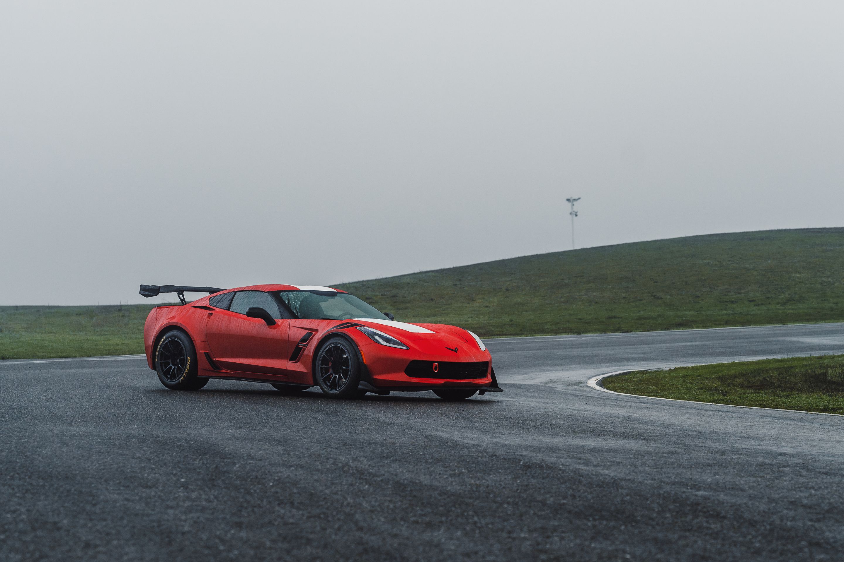 Red Chevrolet C7 Corvette Grand Sport with 18" SM-10RE Apex wheels in Satin Black