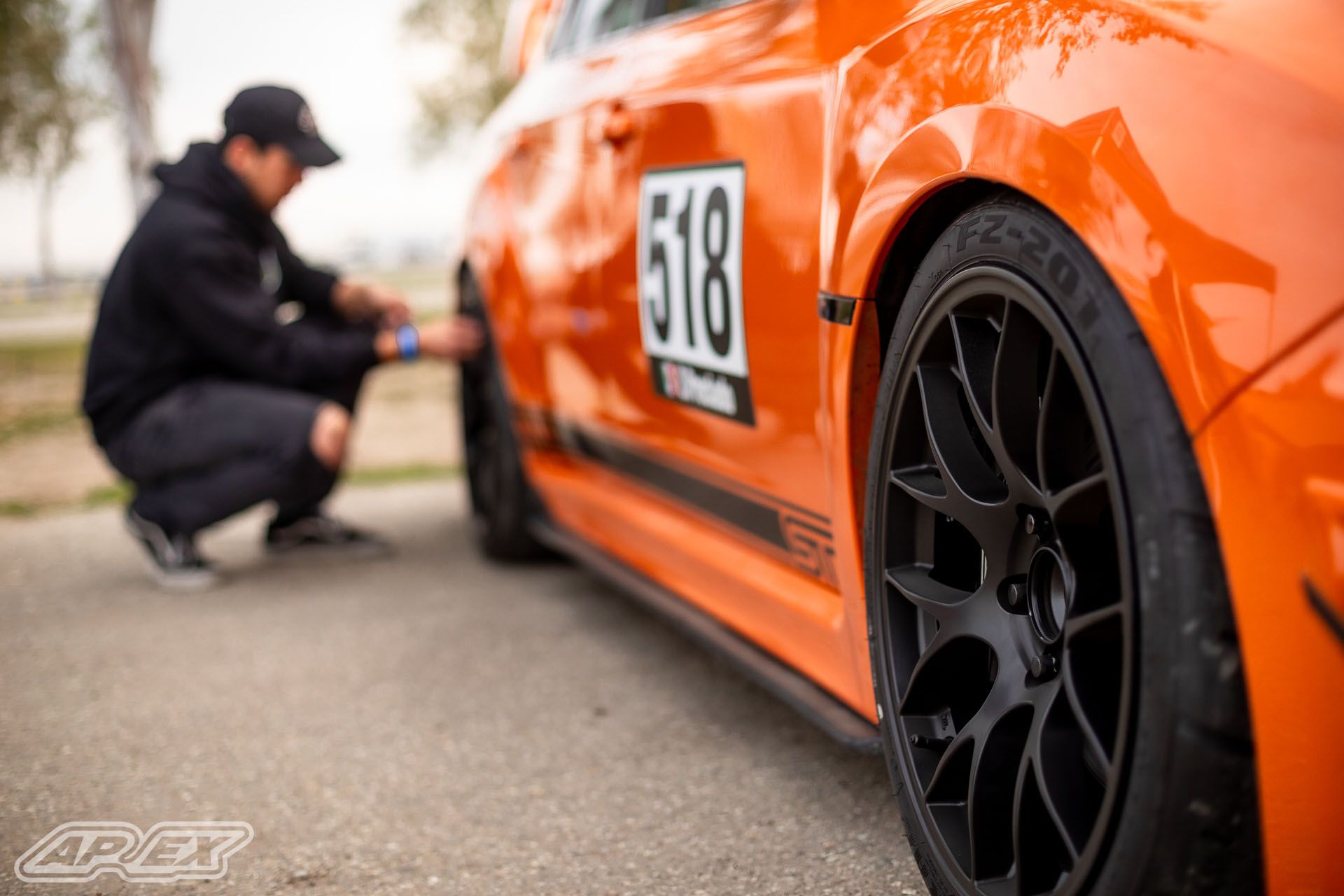 Orange Subaru GR WRX STI with 18" EC-7 Apex wheels in Satin Black